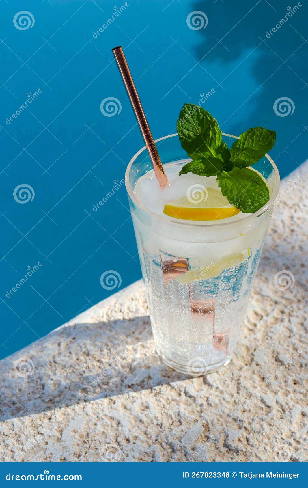 Refreshing Glass of Water with Lemon and Mint at the Pool Stock Photo