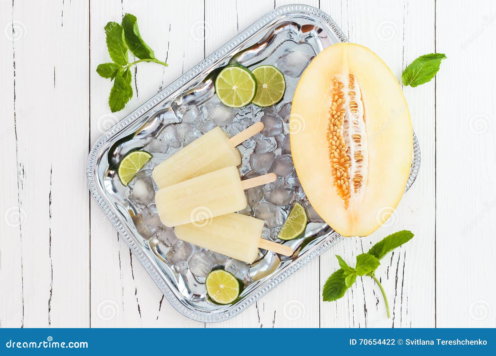 refreshing ice pops over silver tray. lime, honeydew white sangria paletas - popsicles. top view
