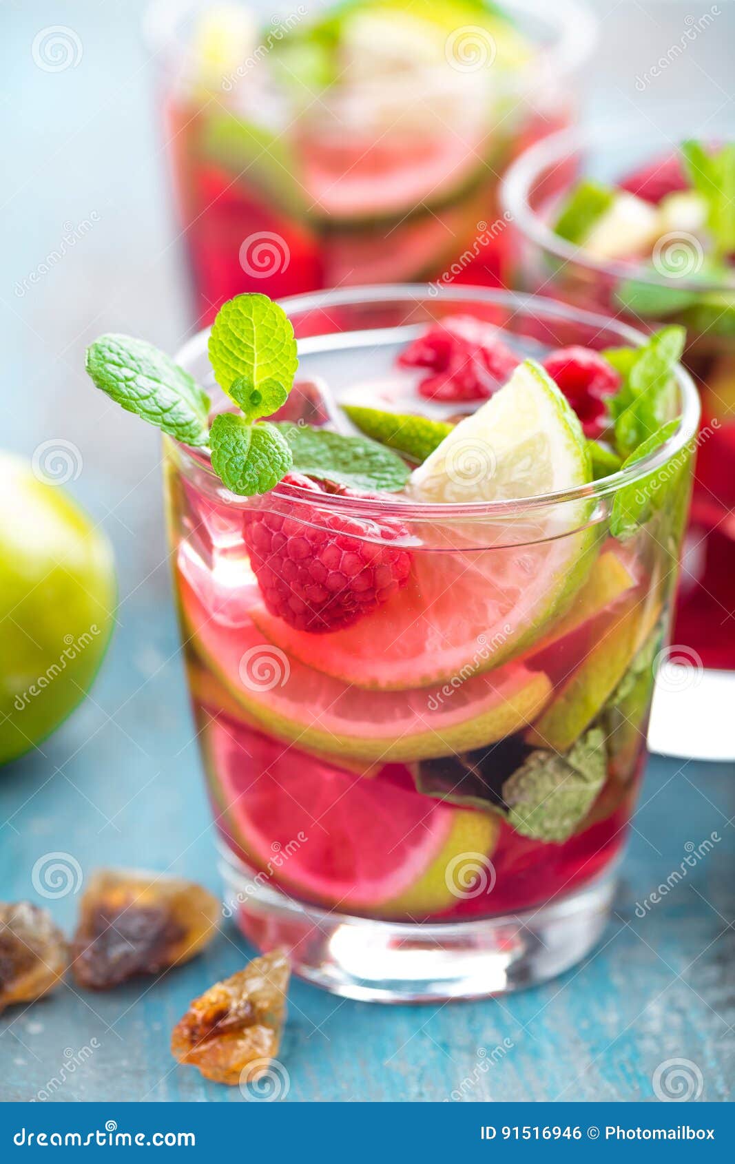Refreshing Mint Cocktail Mojito with Rum, Lime and Raspberry, Cold Drink or Beverage Stock Photo