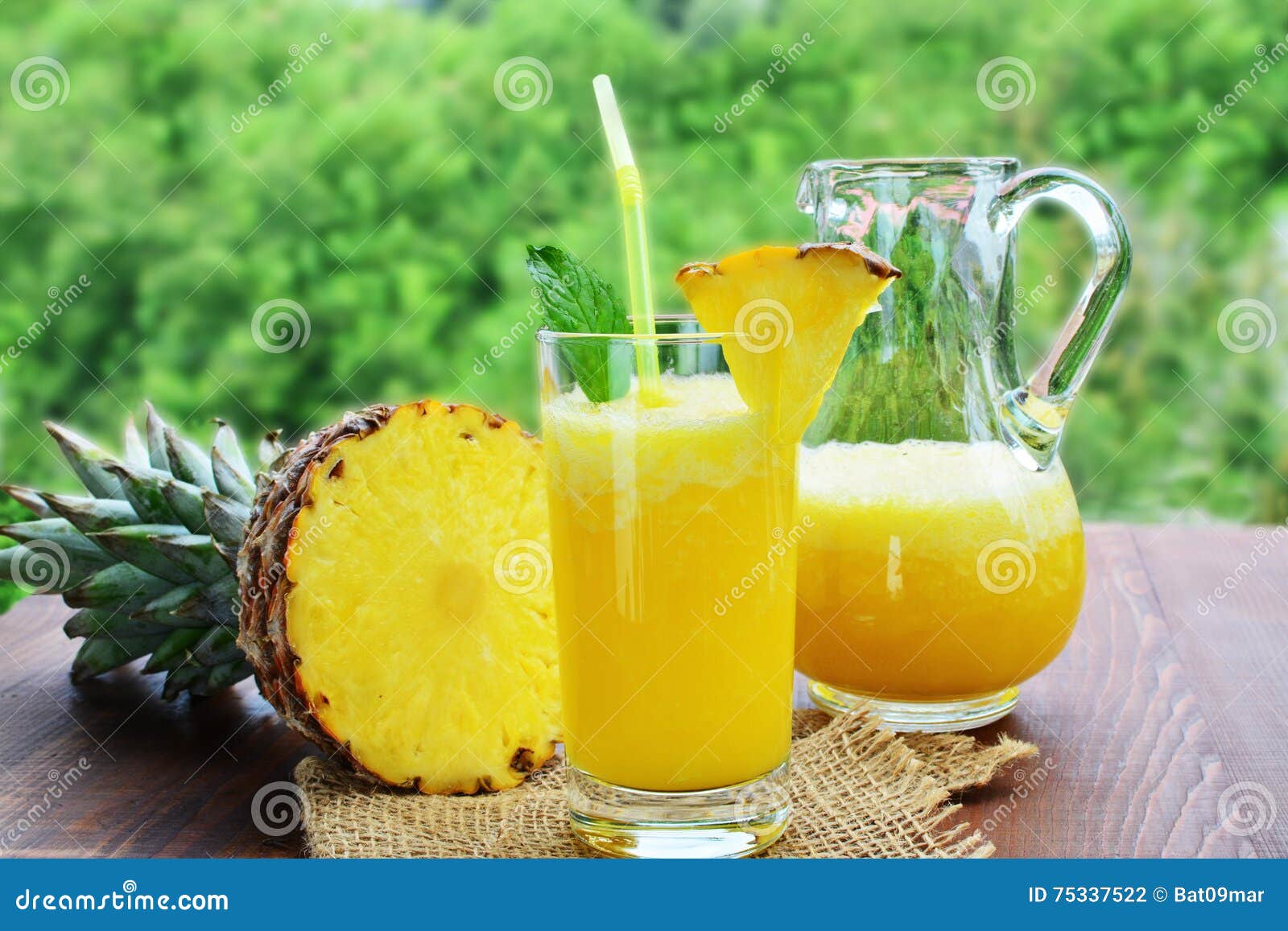 Refreshing Pineapple Mocktail Drink in Glass and Pitcher Stock Photo