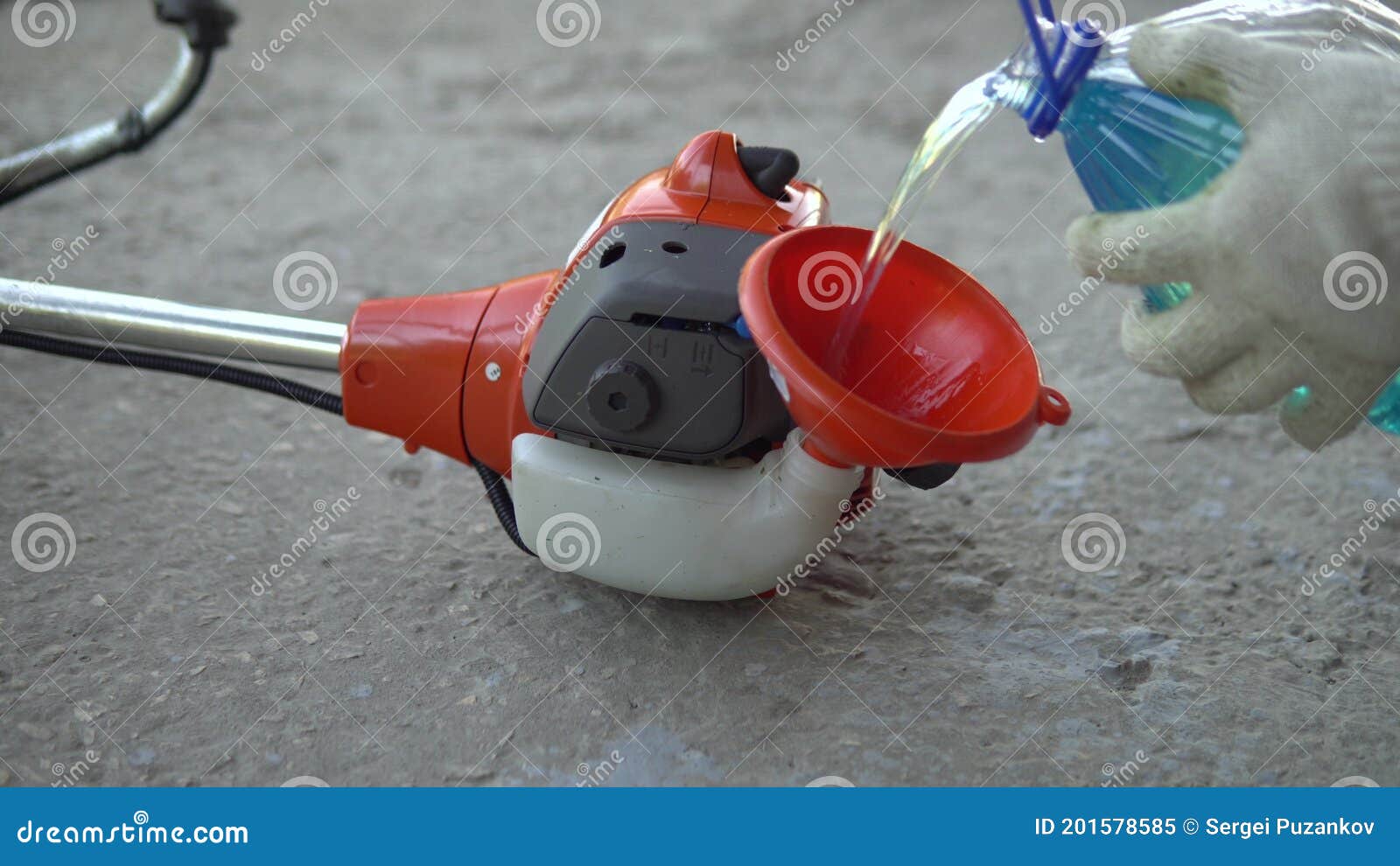Refueling a Lawn Mower with Gasoline in a Gas Tank before Work Stock