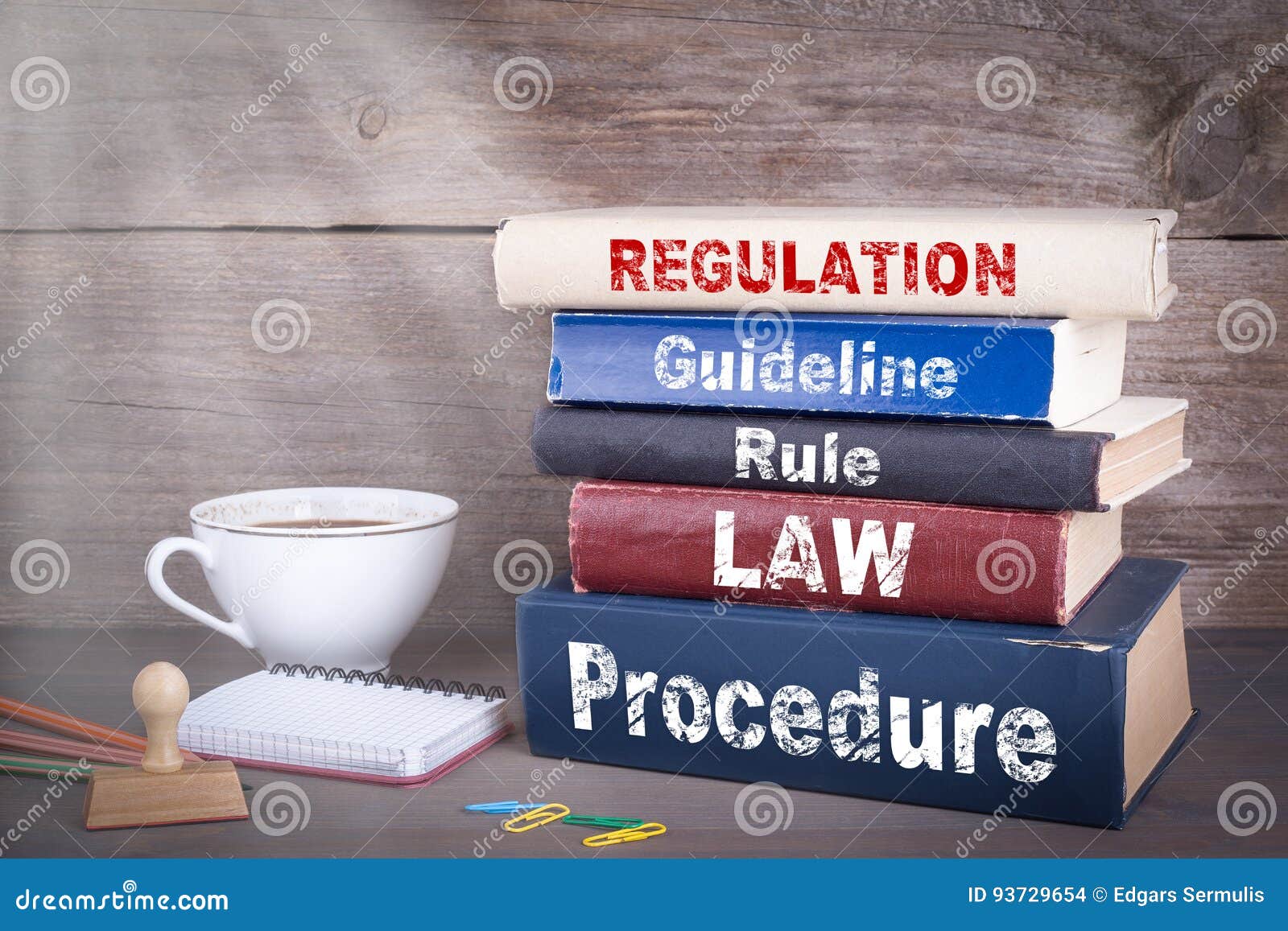 regulation concept. stack of books on wooden desk
