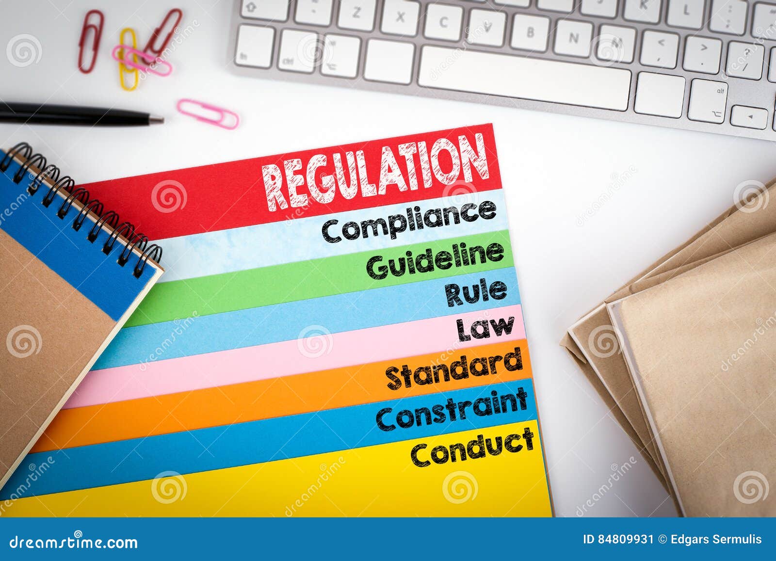 Regulation. Office Desk with a Computer Keyboard and Color Pages Stock