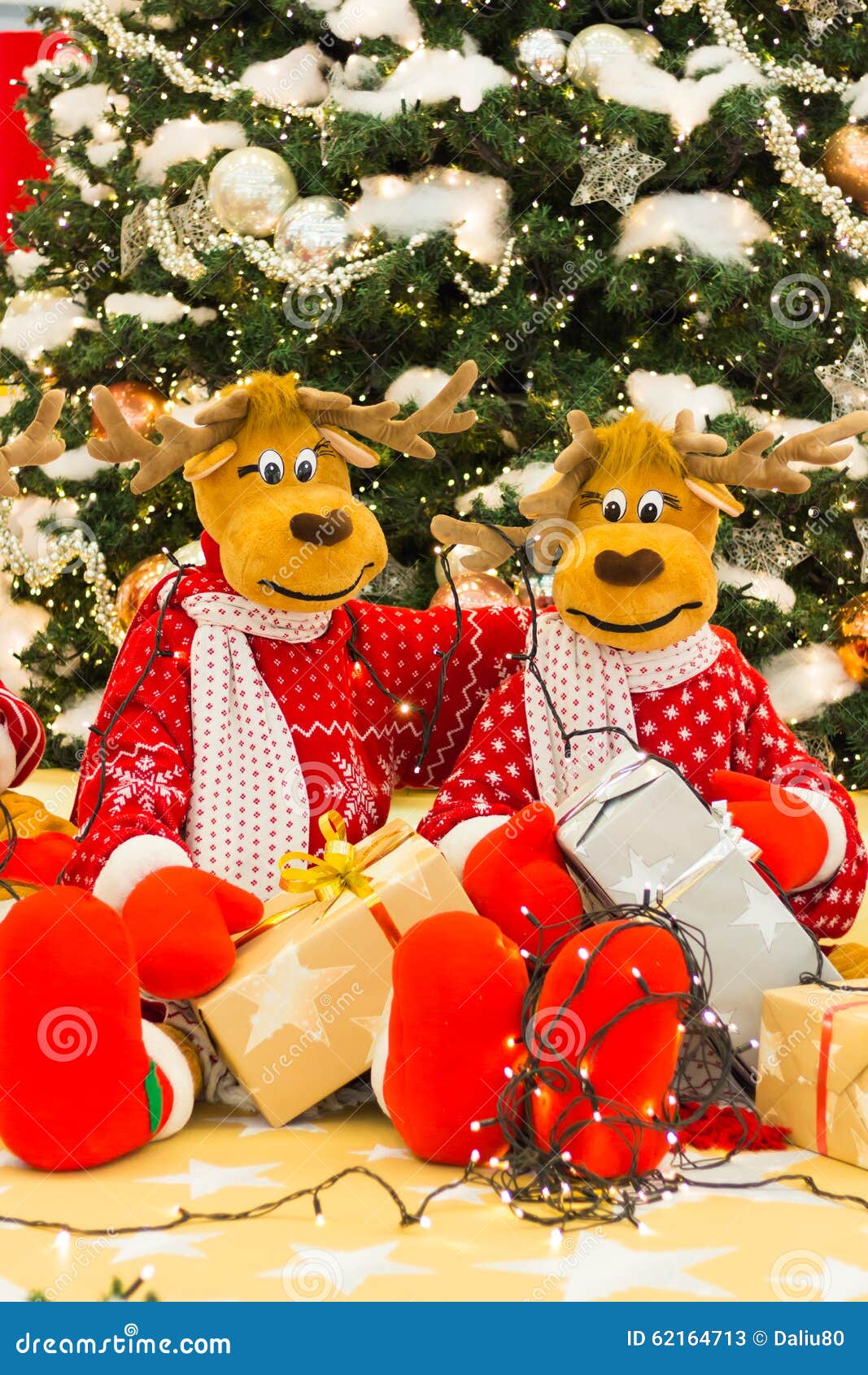 Reindeer Preparing Christmas Tree Lights and Presents Stock Image