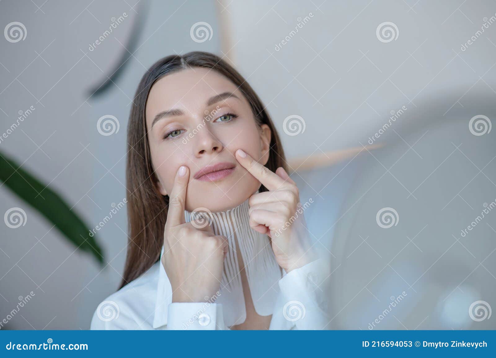 Cute Young Woman Doing Face Massage And Looking Relaxed Stock Image