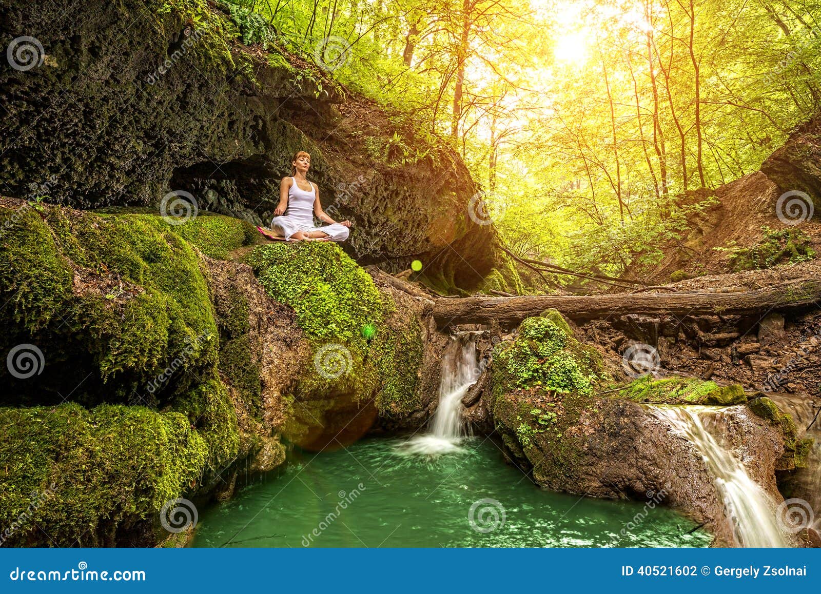 relaxation in forest at the waterfall. ardha padmasana pose