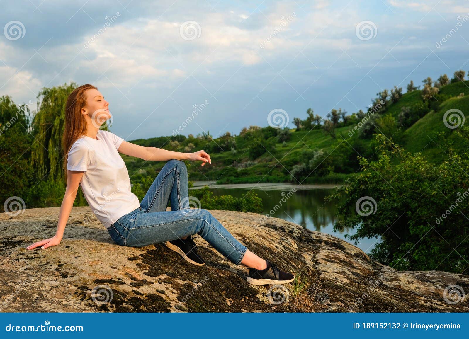 relaxation, meditation mental health concept. national relaxation day. red-haired woman meditates and relaxes in nature