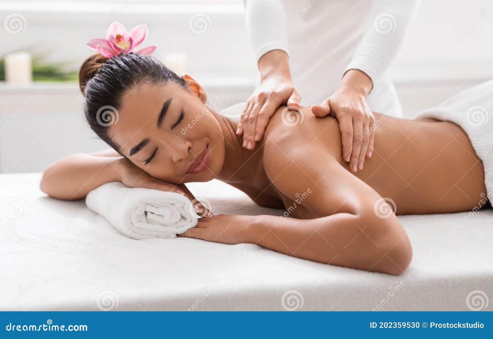 Asian Girl Relaxing Having Arm Massage in a Spa Salon, Close Up