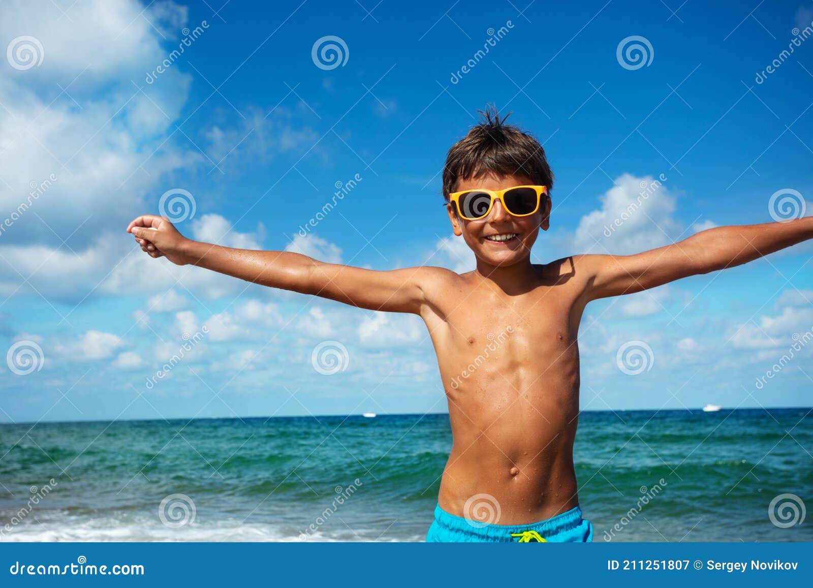 Relaxed Boy in Shades and Smile Lift Hands by Sea Stock Image - Image ...