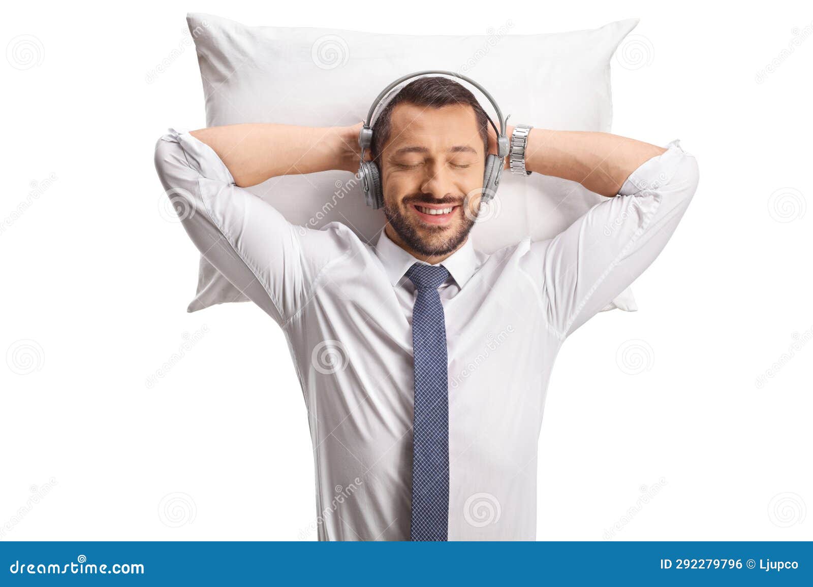 Relaxed Businessman Sleeping on a Pillow with Headphones Stock