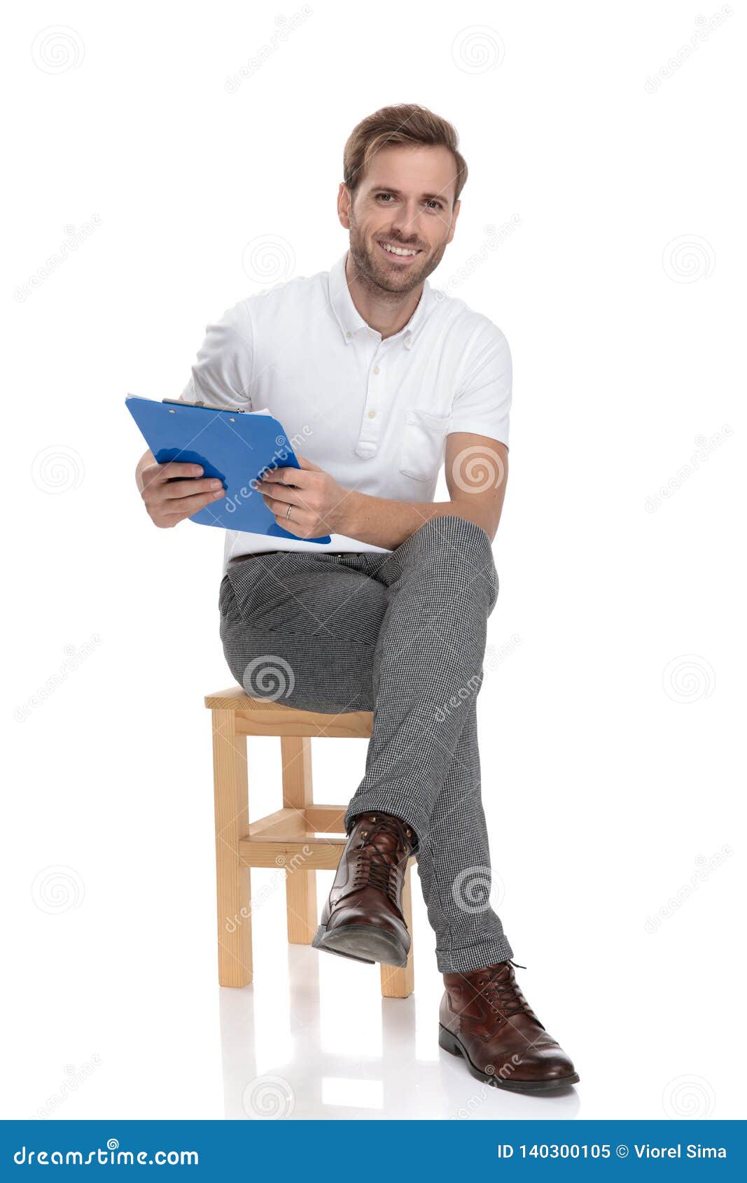 Relaxed Casual Man Sitting and Holding a Blue Clipboard Stock Image ...