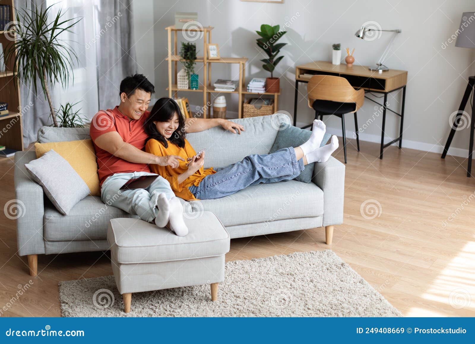 https://thumbs.dreamstime.com/z/relaxed-japanese-couple-chilling-together-home-using-gadgets-relaxed-japanese-couple-chilling-together-weekend-home-249408669.jpg