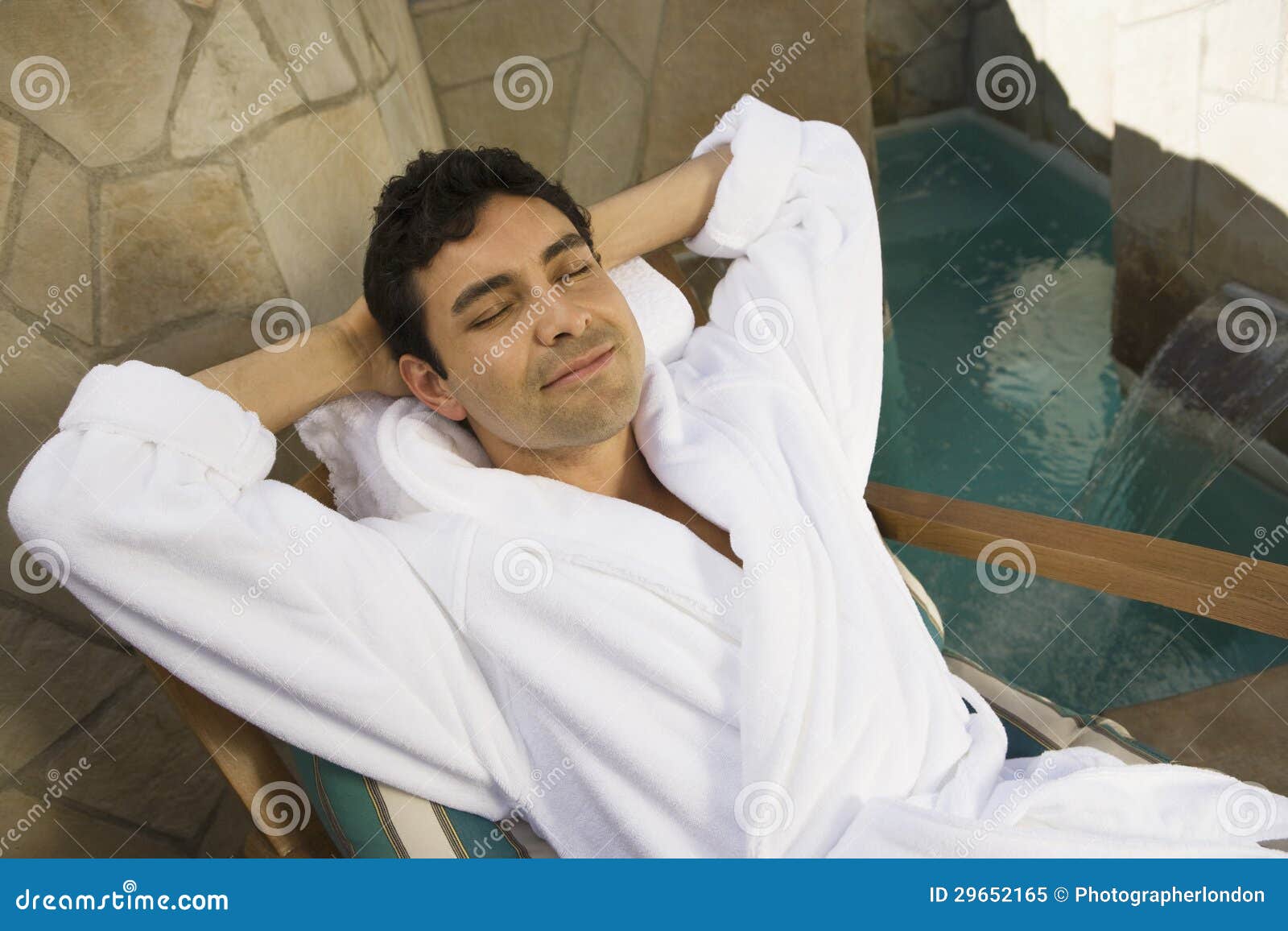 relaxed man in bathrobe sitting on chair