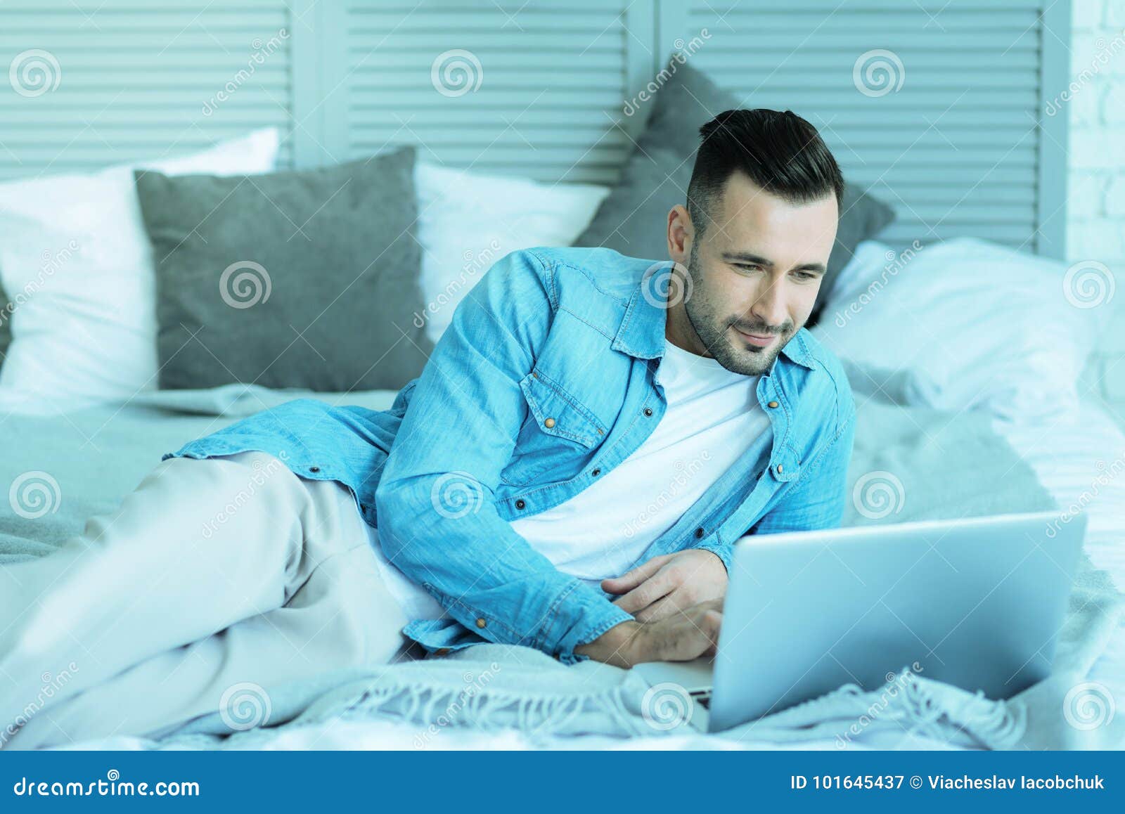 Relaxed Millennial Guy Lying In Bed With Laptop Stock Image Image Of Literacy Networking