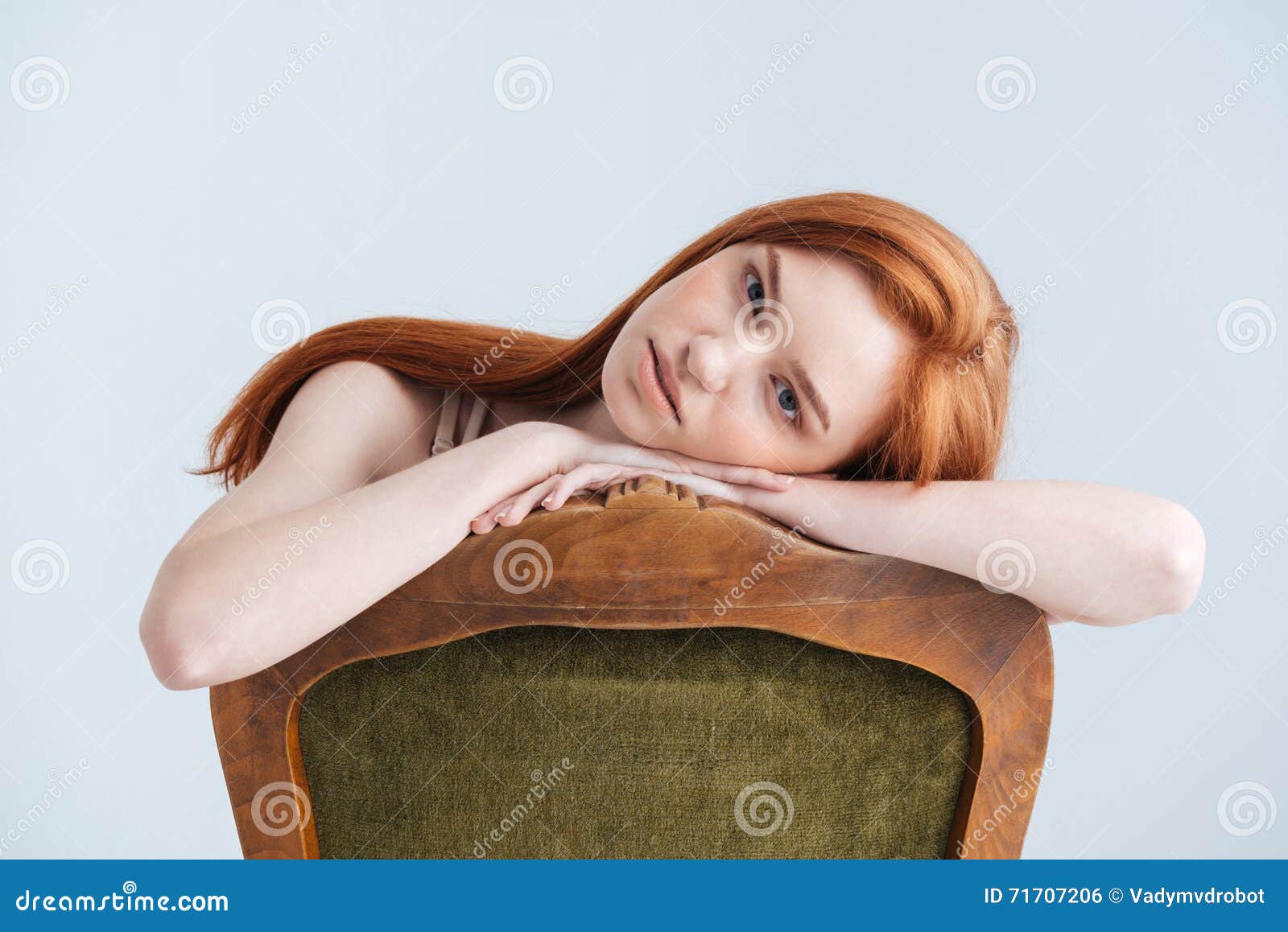relaxed redhead woman sitting on the chair
