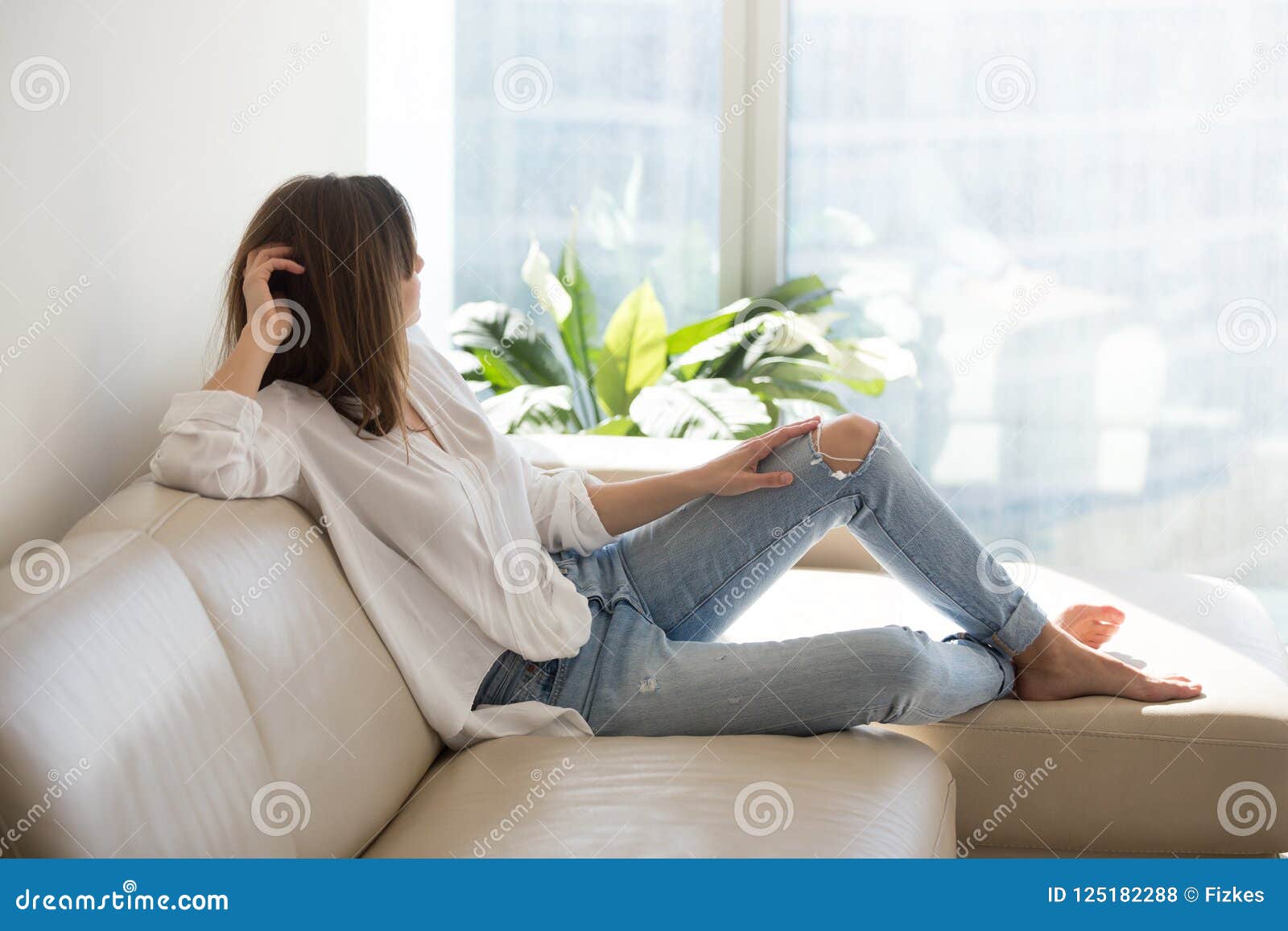 relaxed thoughtful woman enjoying wellbeing dreaming at luxury l