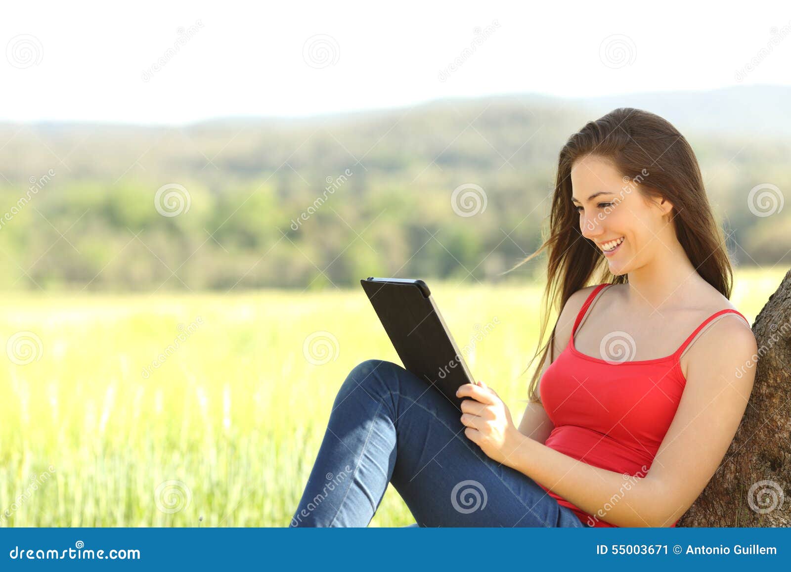 relaxed woman reading an ebook in the country