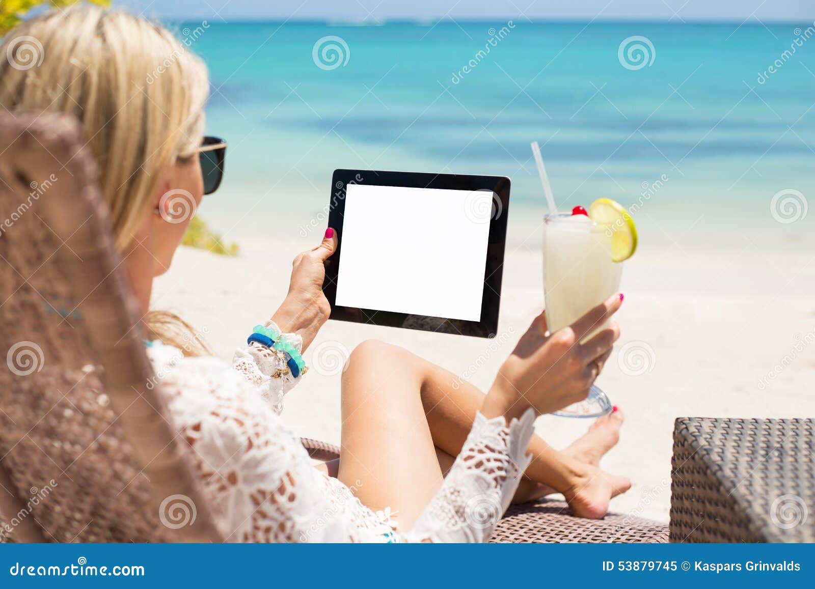 relaxed woman using tablet computer on the beach