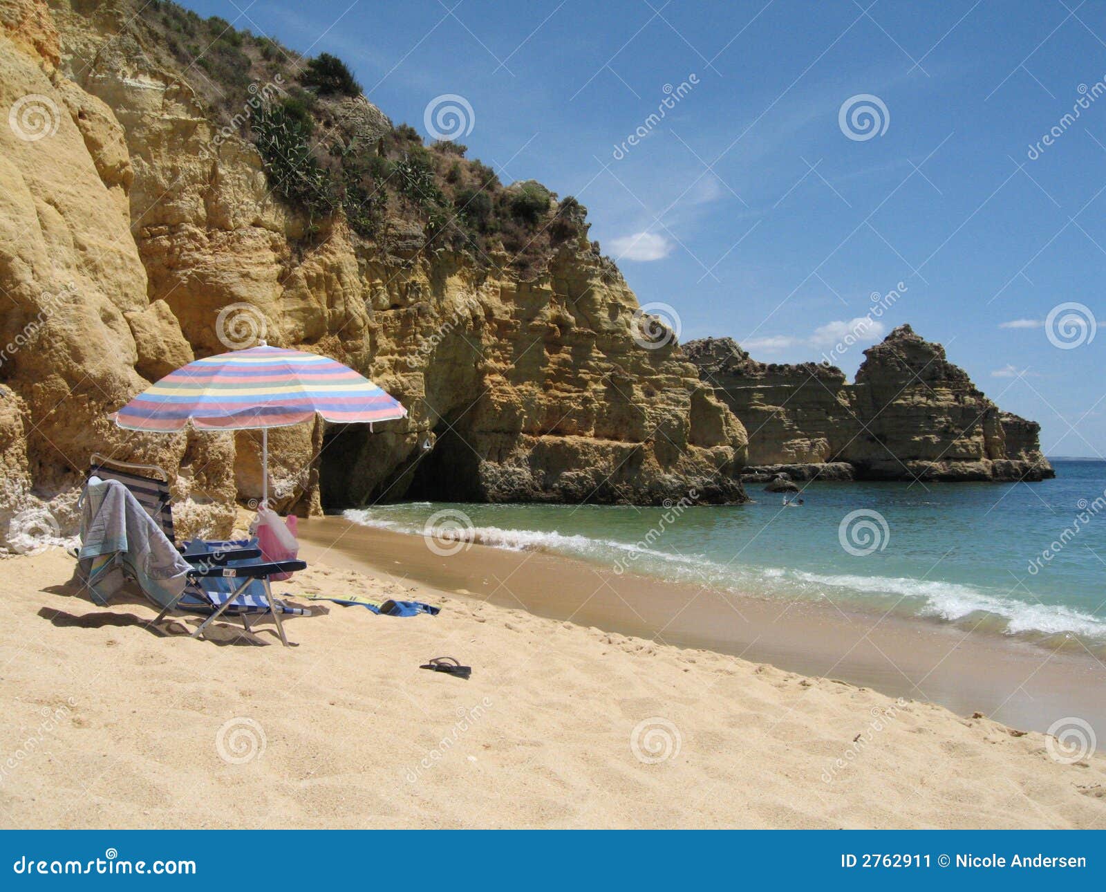 Relaxing on the Algarve. Umbrella and beach chairs on Algarve beach