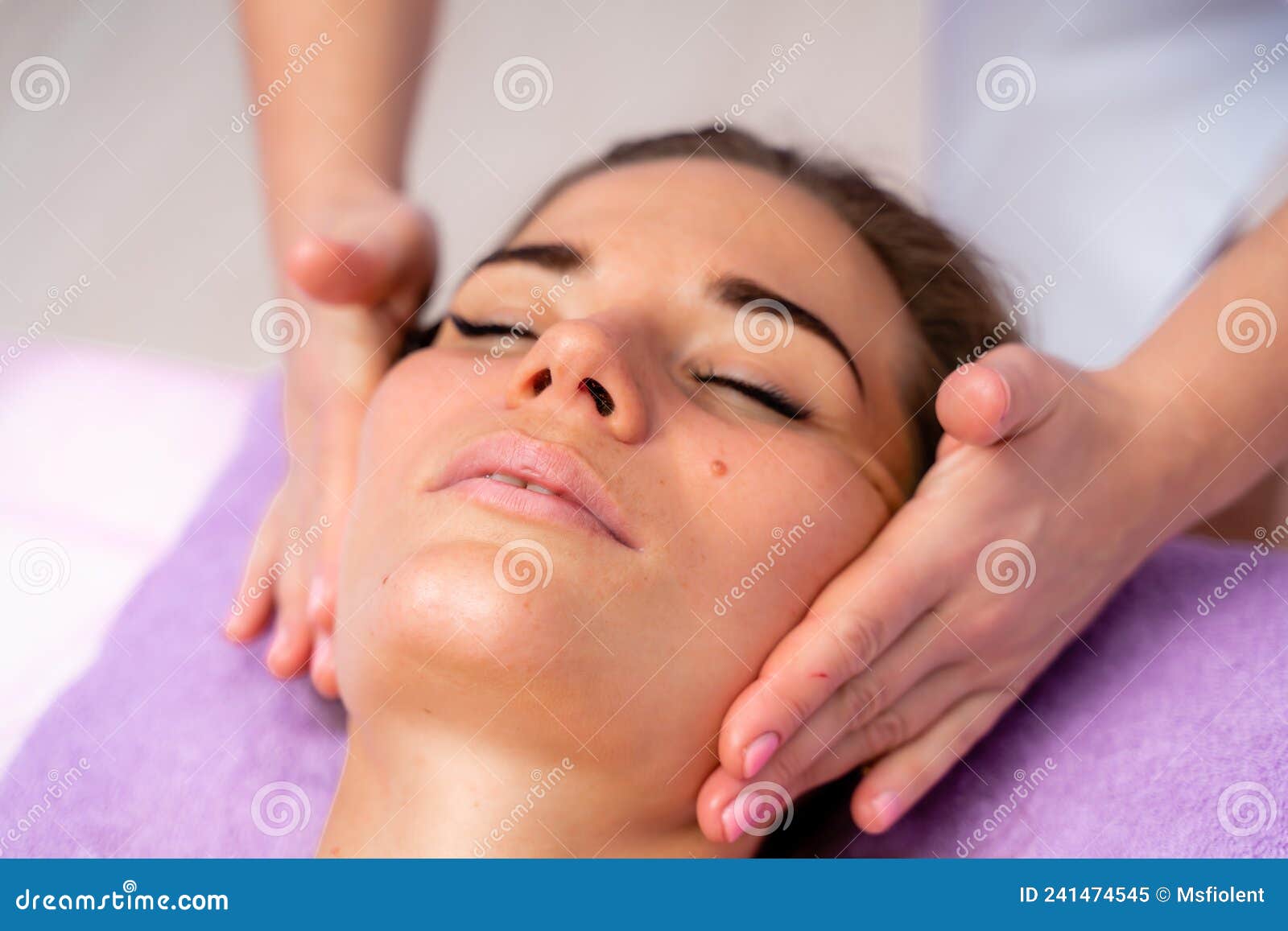 Relaxing Massage European Woman Getting Facial Massage In Spa Salon Side View Stock Image