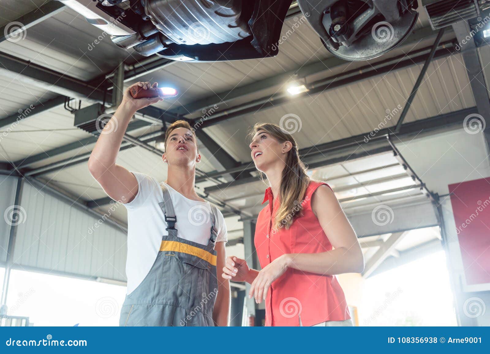 reliable auto mechanic checking the car of a woman in a modern a