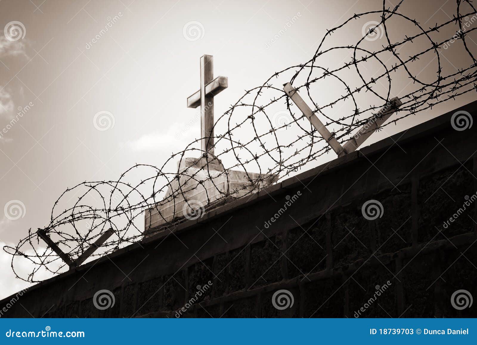 religion and war - cross behind barbed wire