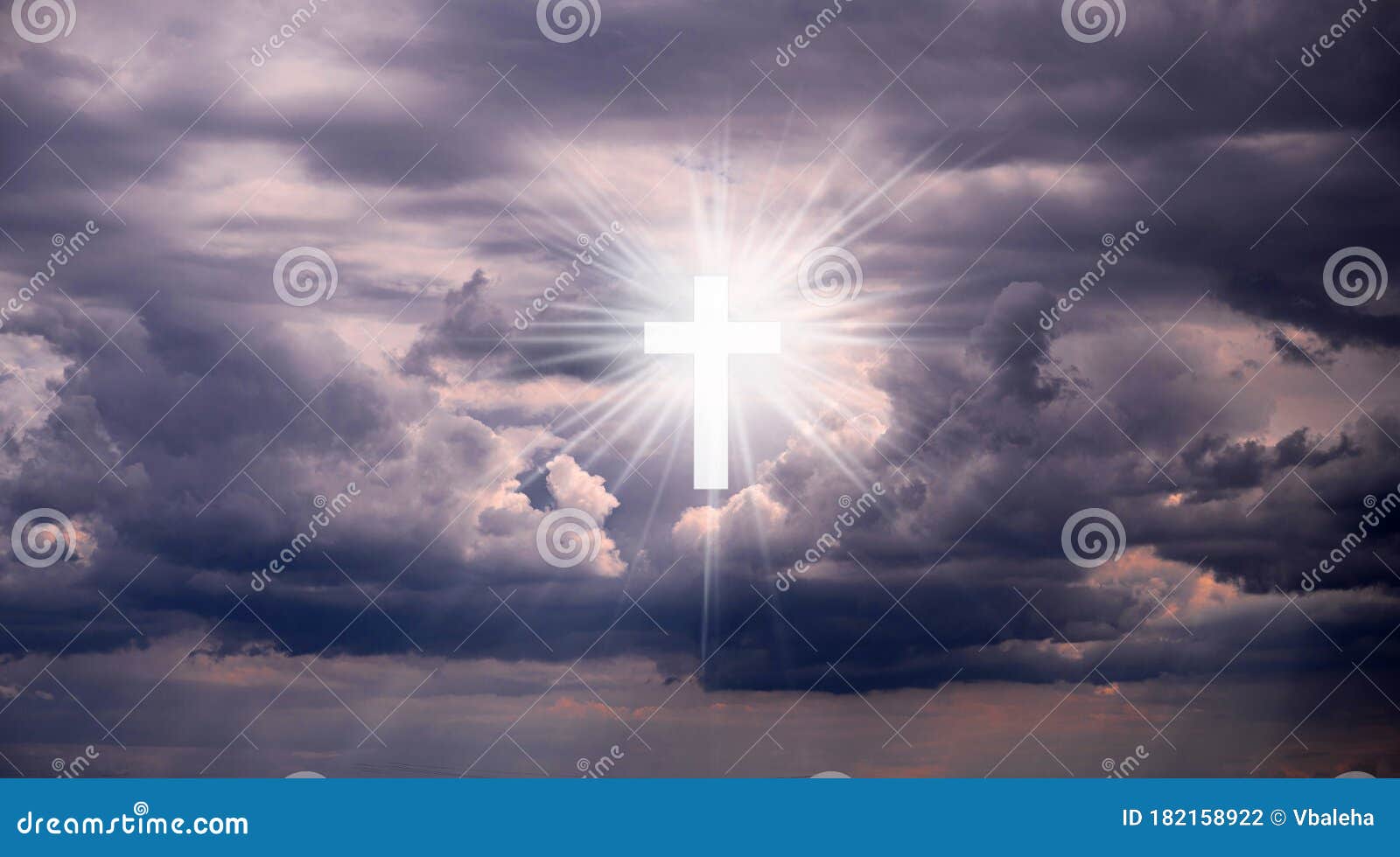 religious background with holy cross glowing. christian cross in a sky with some clouds