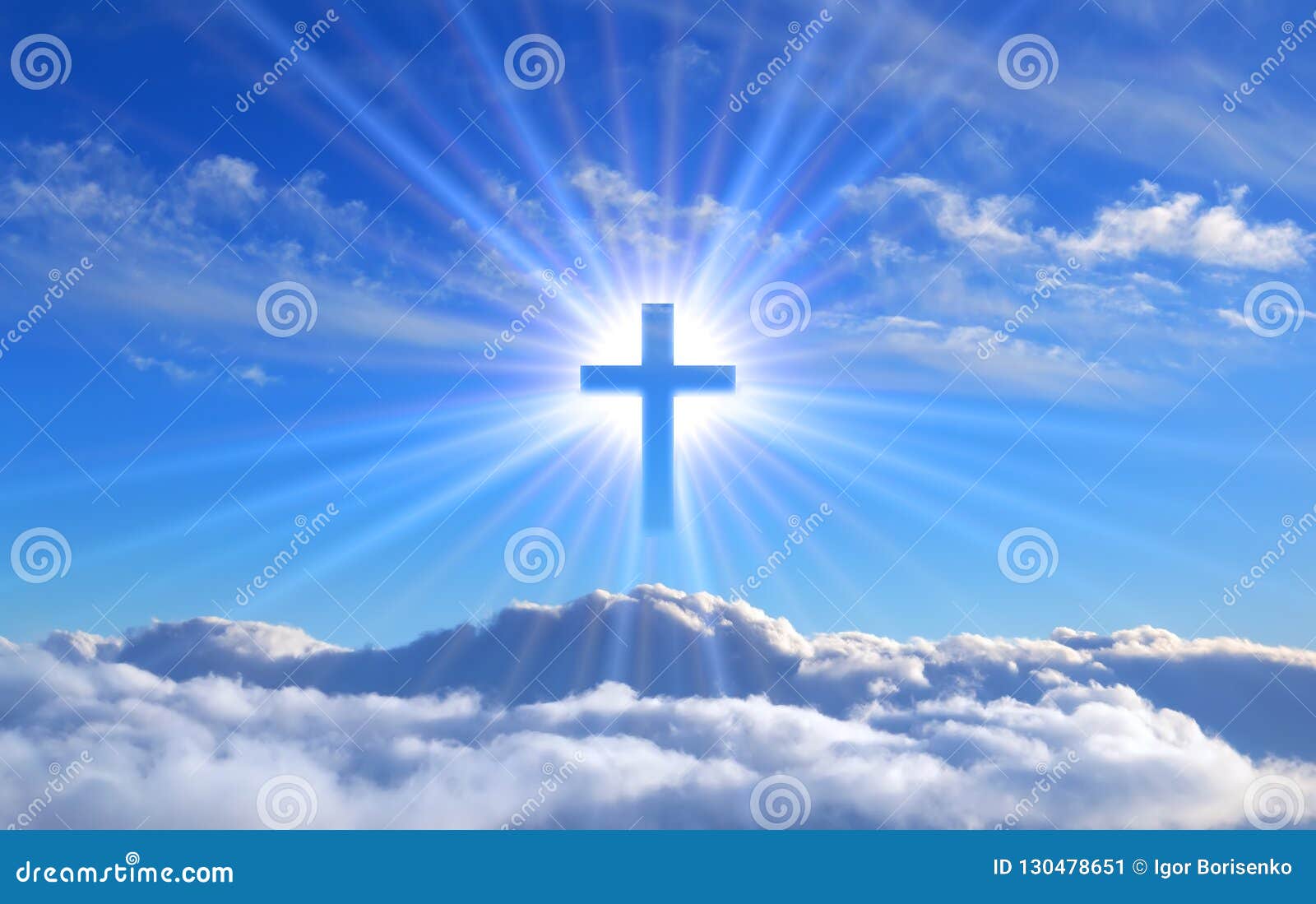 religious cross over cumulus clouds illuminated by the rays of holy radiance, concept.