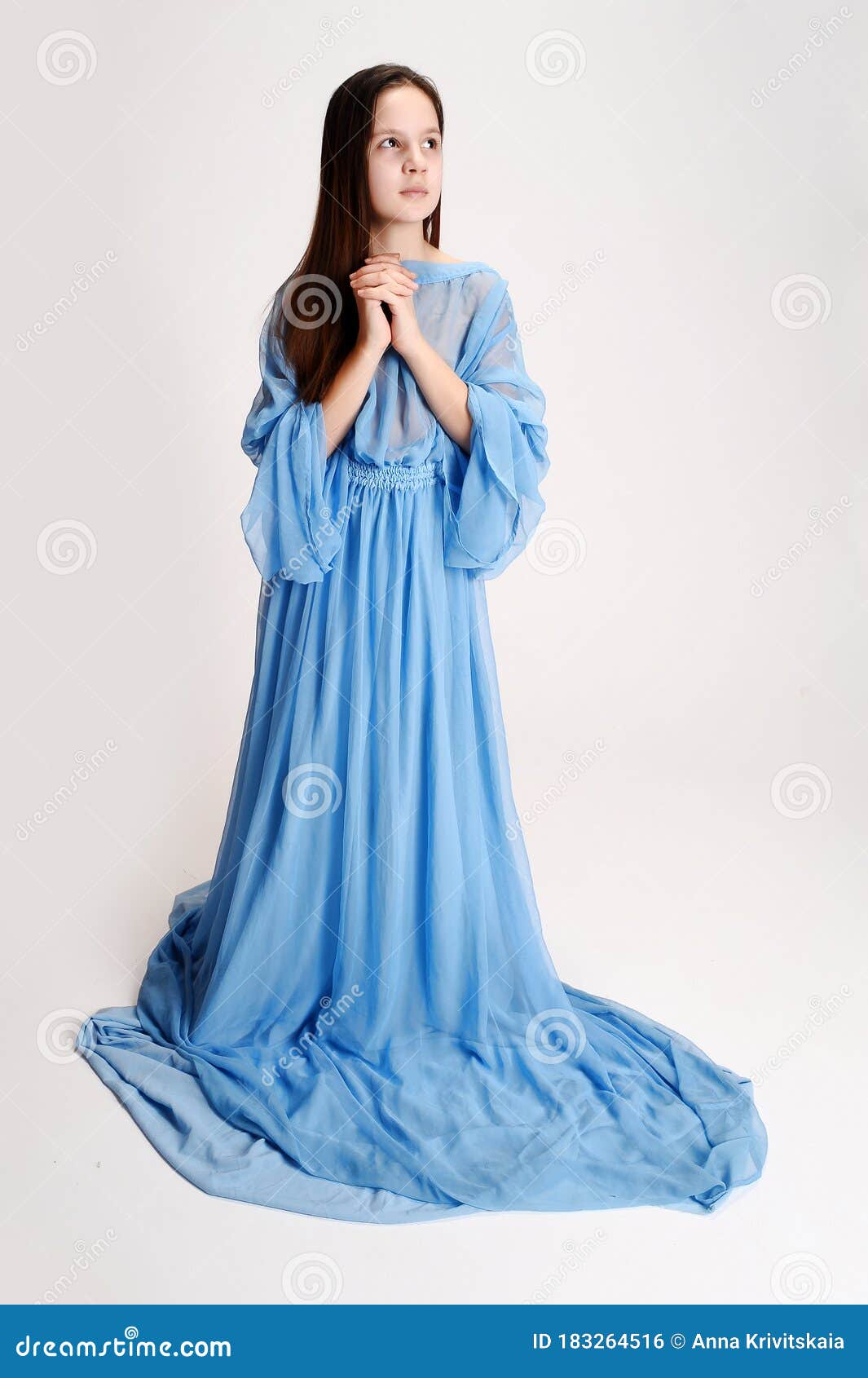 Religious Girl in a Blue Dress Stock Photo Image of background