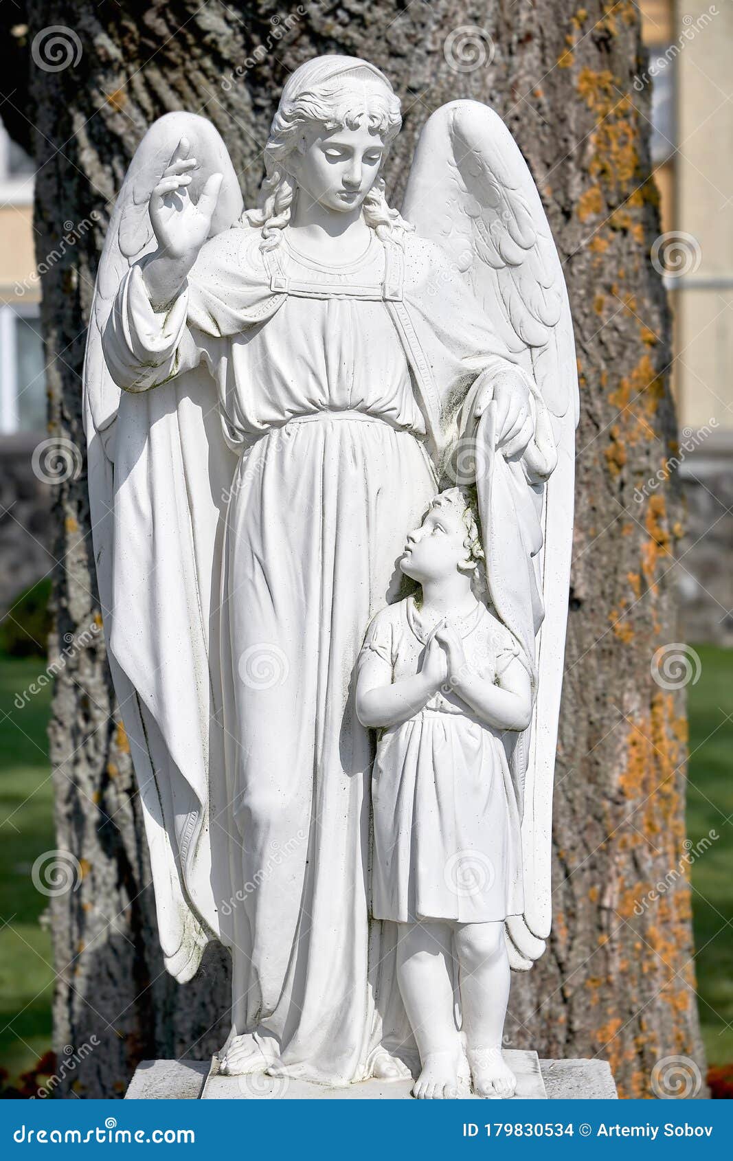 religious monument of the guardian angel. monument to the angel made of white stone