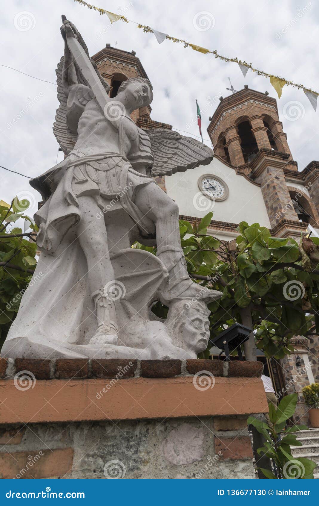 religious statue outside the parroquia de san miguel arcangel pitillal puerto vallarta