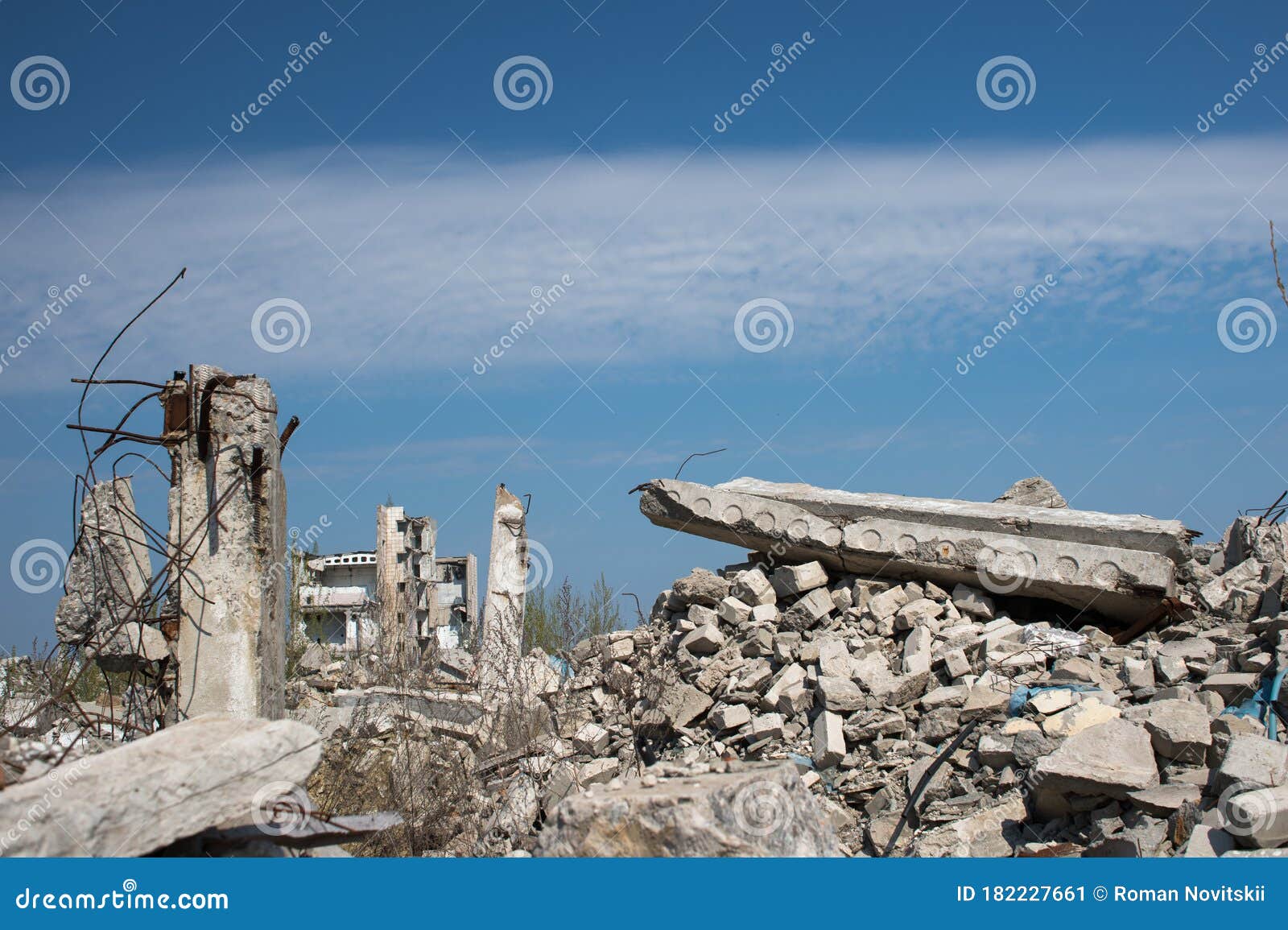 The Remains of a Destroyed Building Against a Textured Blue Sky Stock
