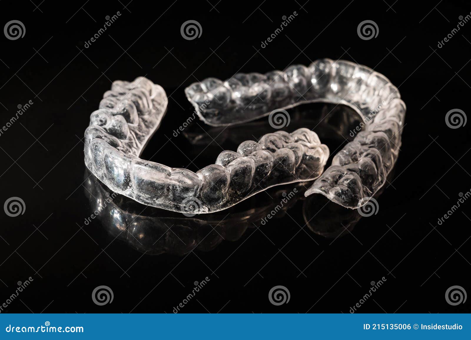 Removable Plastic Retainers for Bite Correction on a Black Background