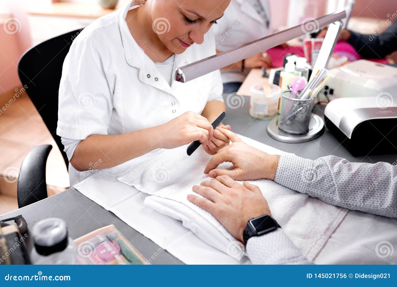 removing of the sharp nail edges during manicure treatment with emery board