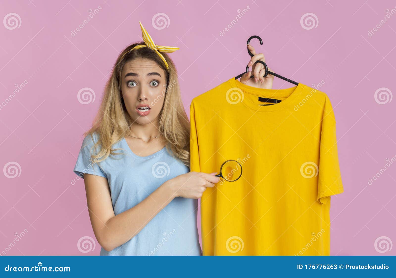 removing stains from clothing concept. housewife with magnifier