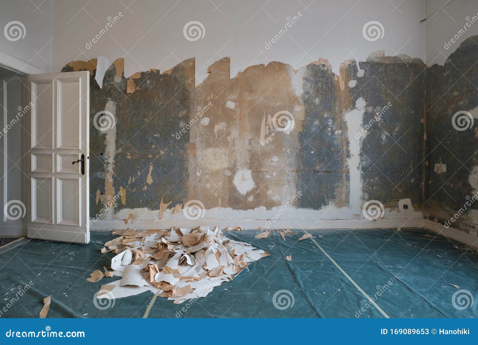 removing wallpaper from wall in room during flat renovation