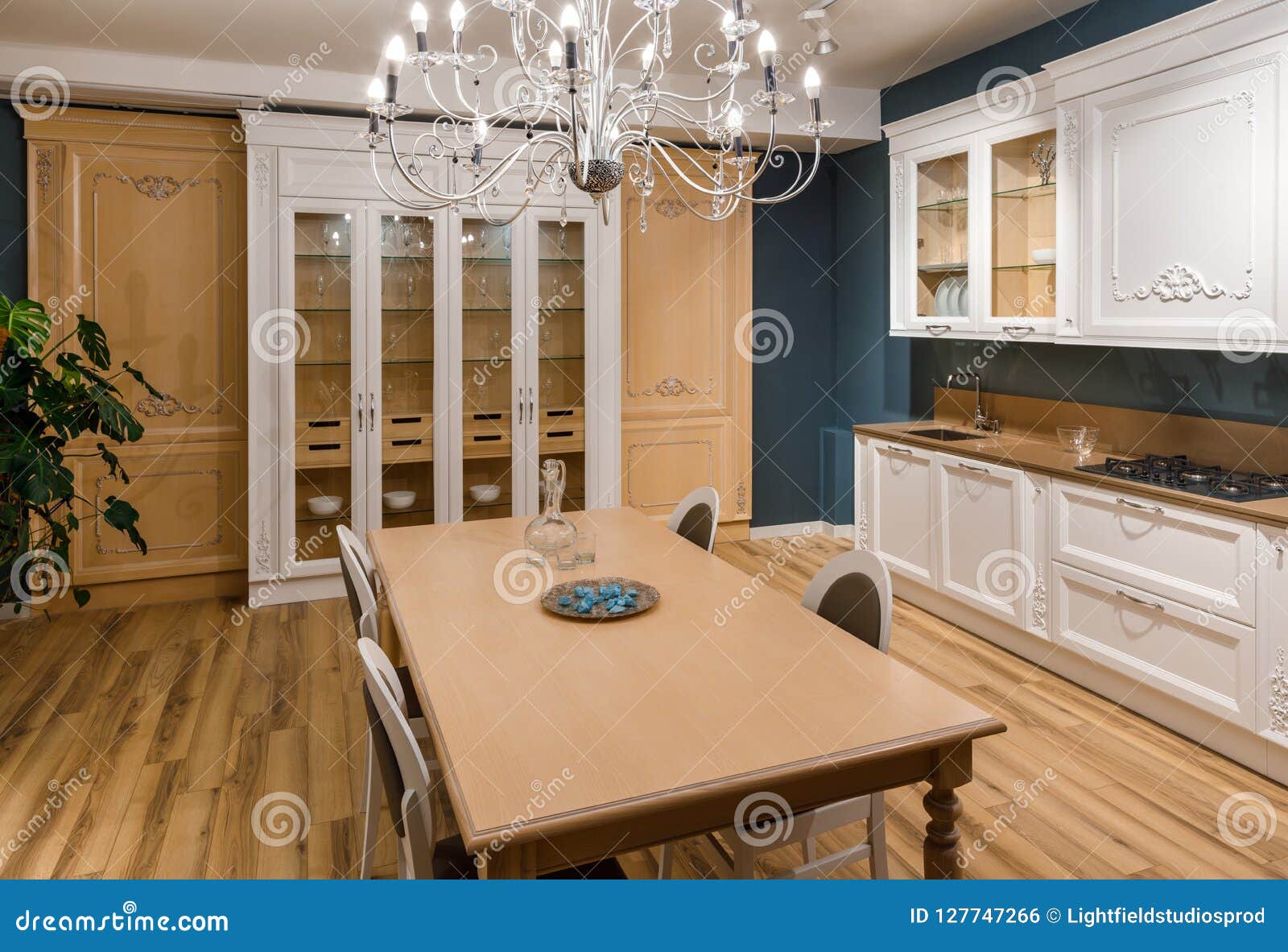 Renovated Kitchen Interior with Chandelier Over Table Stock Photo