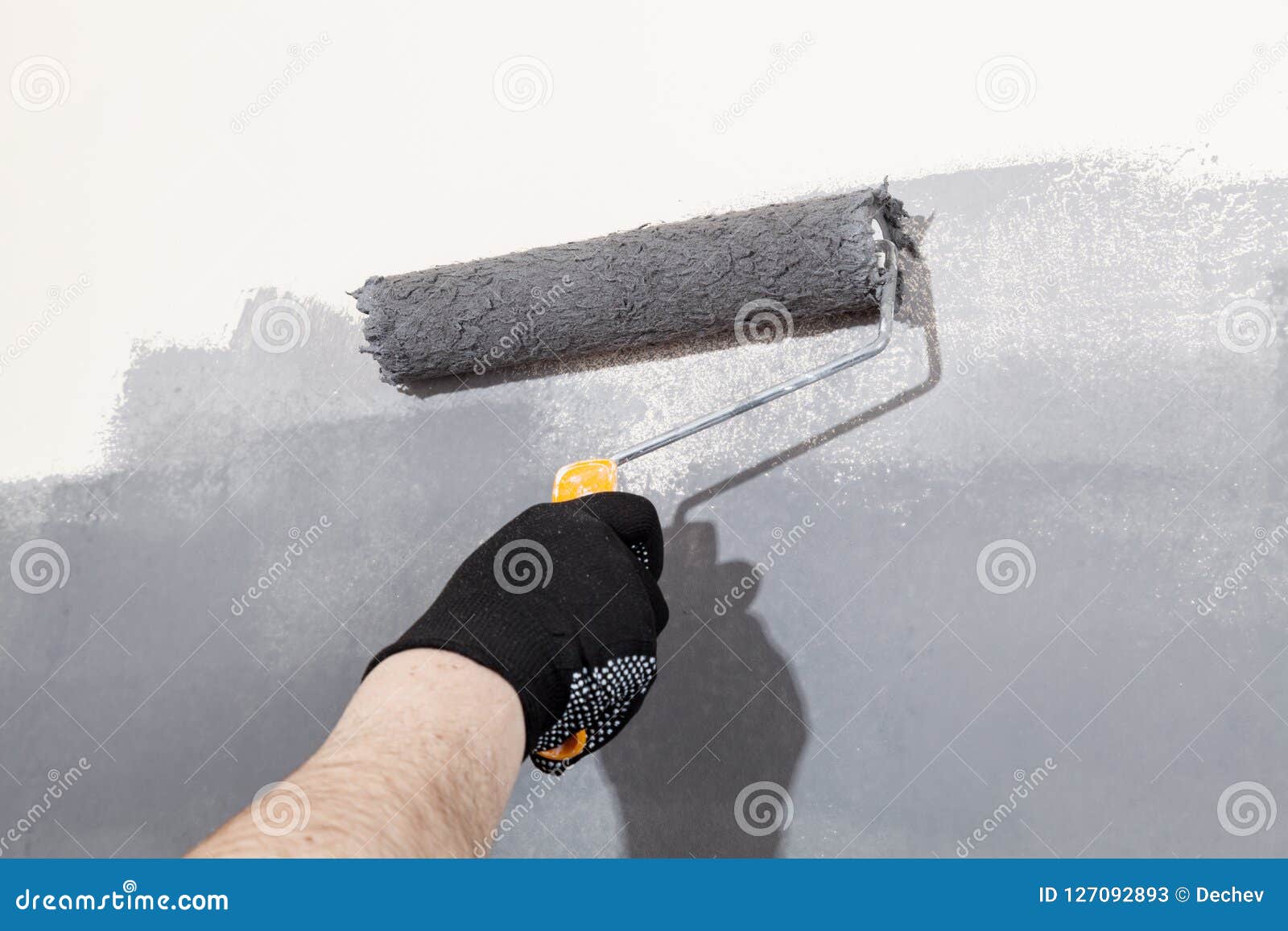 Renovation Of Interior Man Hand Holds Paint Roller And