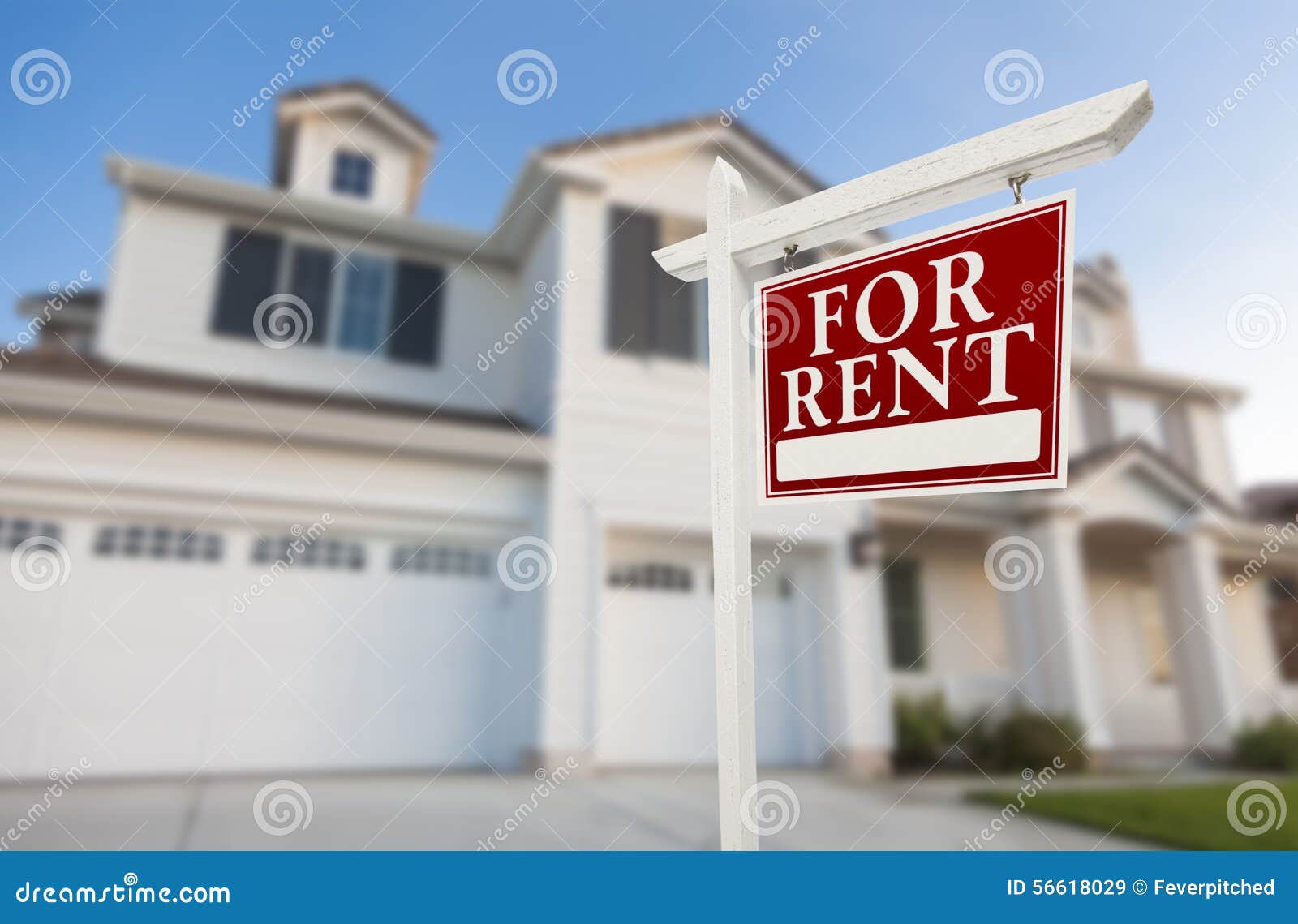 for rent real estate sign in front of house