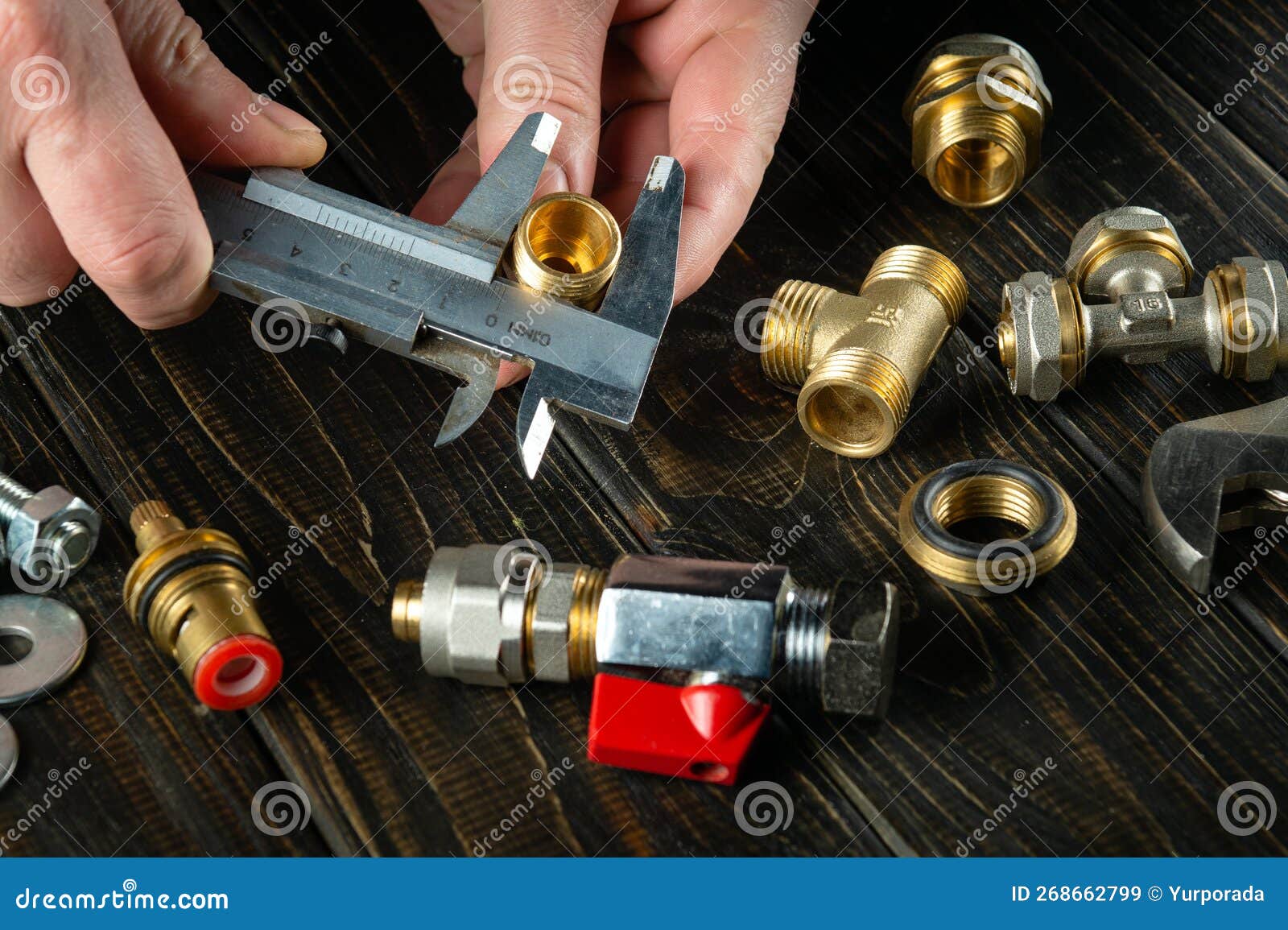 Repair of Plumbing Equipment on the Table in the by the Hands of the Master. Copy Space