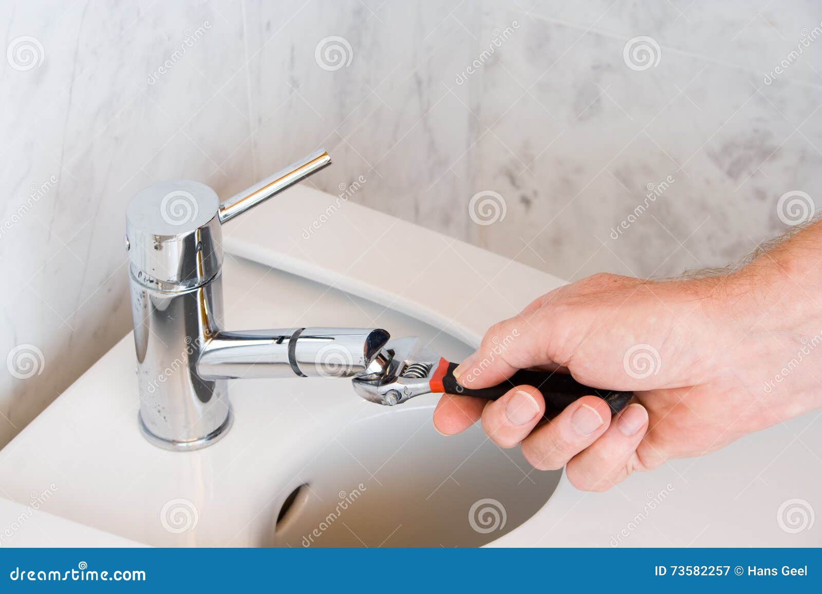Repairing a Faucet in a Bathroom Stock Image Image of handsome
