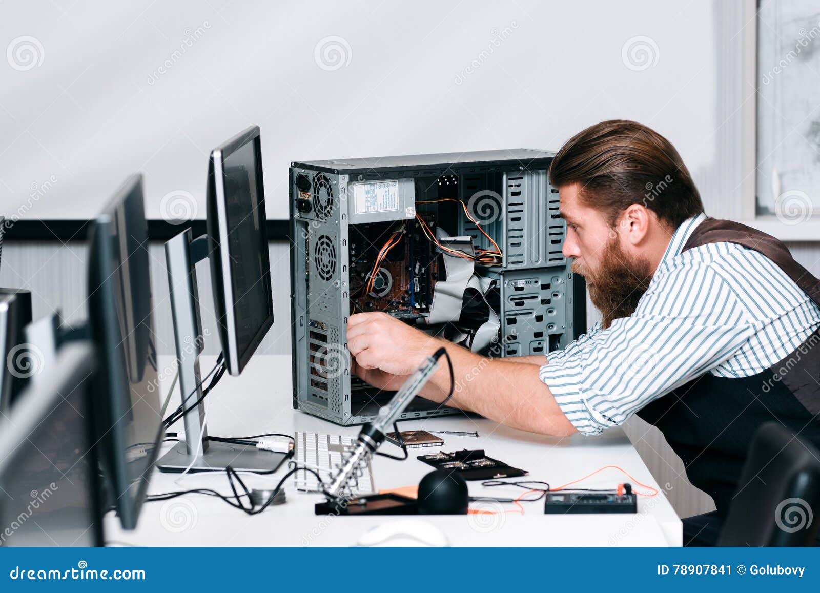 repairman fixing components in computer unit