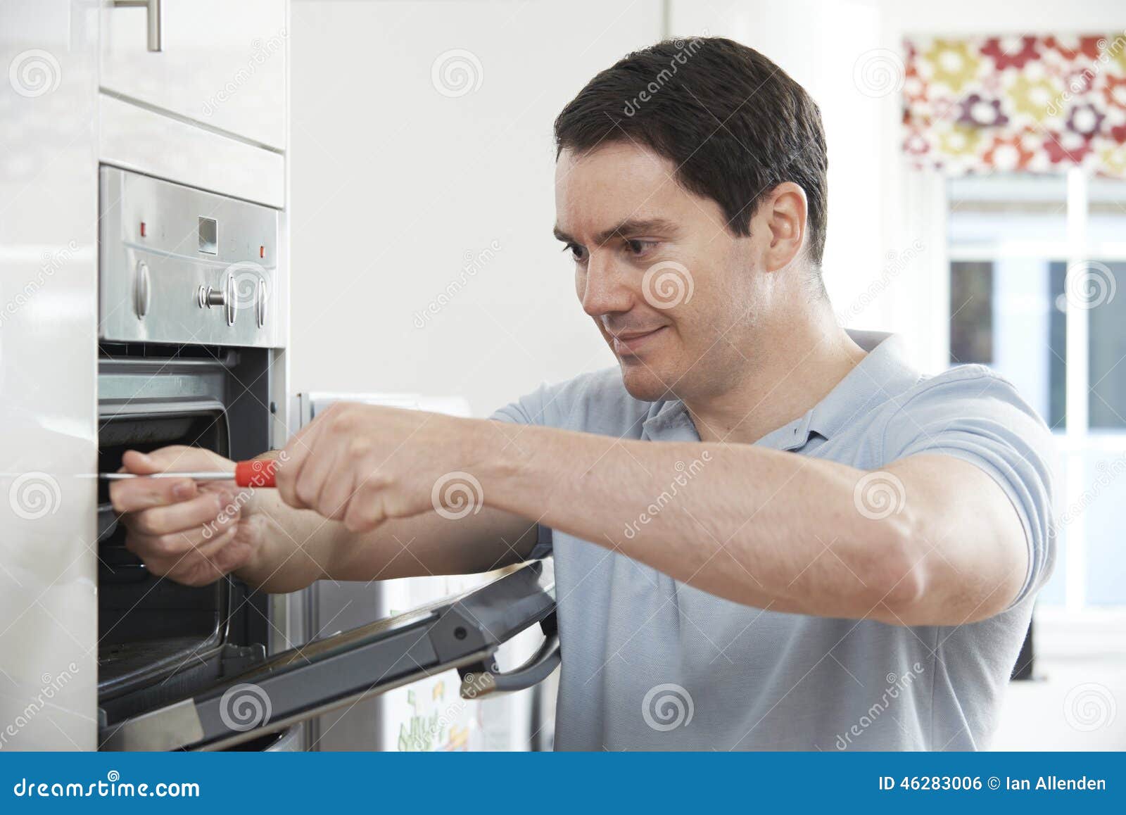 Repairman Fixing Domestic Oven in Kitchen Stock Photo Image of male