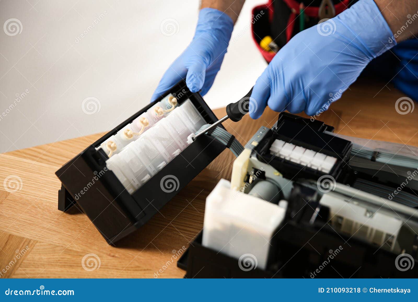 Repairman with Screwdriver Fixing Modern Printer, Closeup Stock Photo
