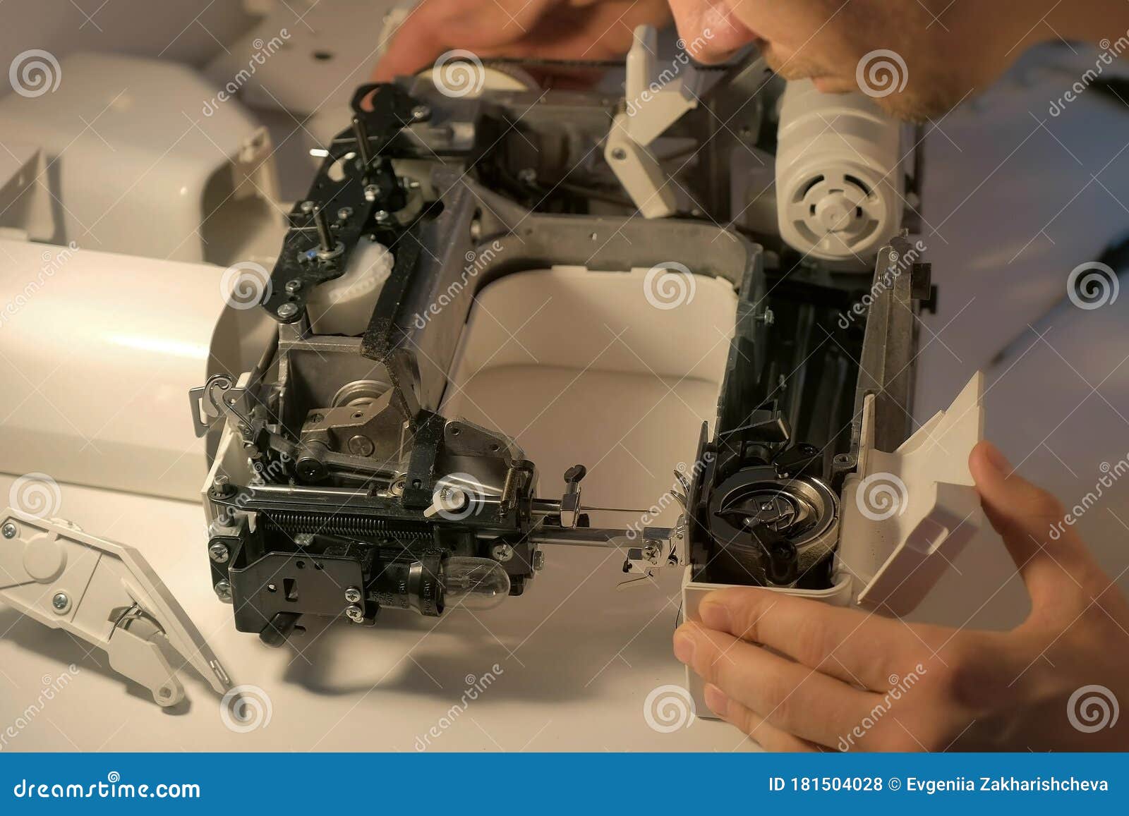 Repairman Testing Disassembles Sewing Machine in Repairing it