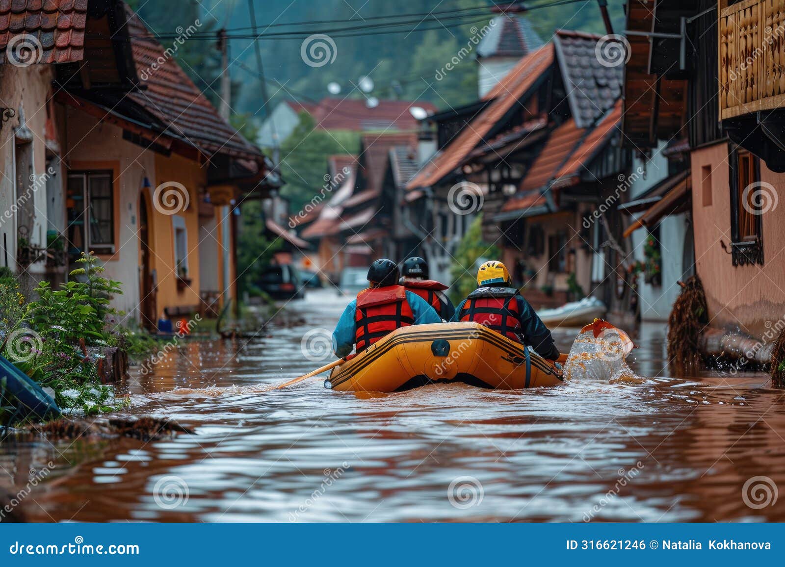 rescue operation. male rescuers sail a boat through the flooded old town during a flood