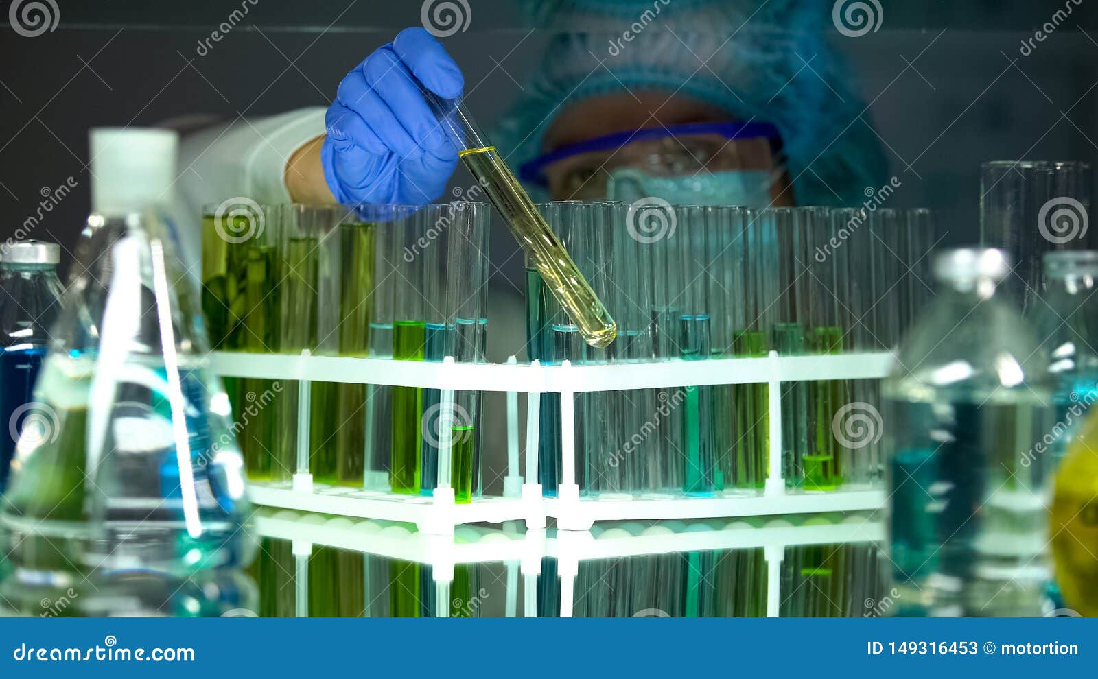 researcher checking sediments in tubes with test liquids, vitamin production