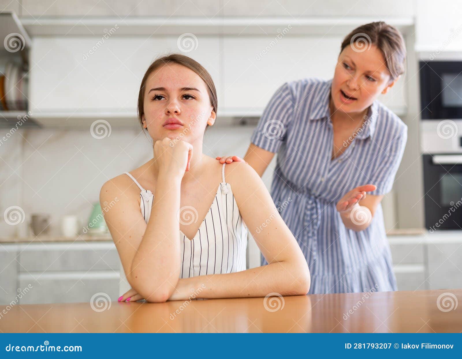 https://thumbs.dreamstime.com/z/resentful-teen-girl-sitting-table-her-mother-speaking-to-her-standing-behind-kitchen-offended-young-girl-sitting-281793207.jpg