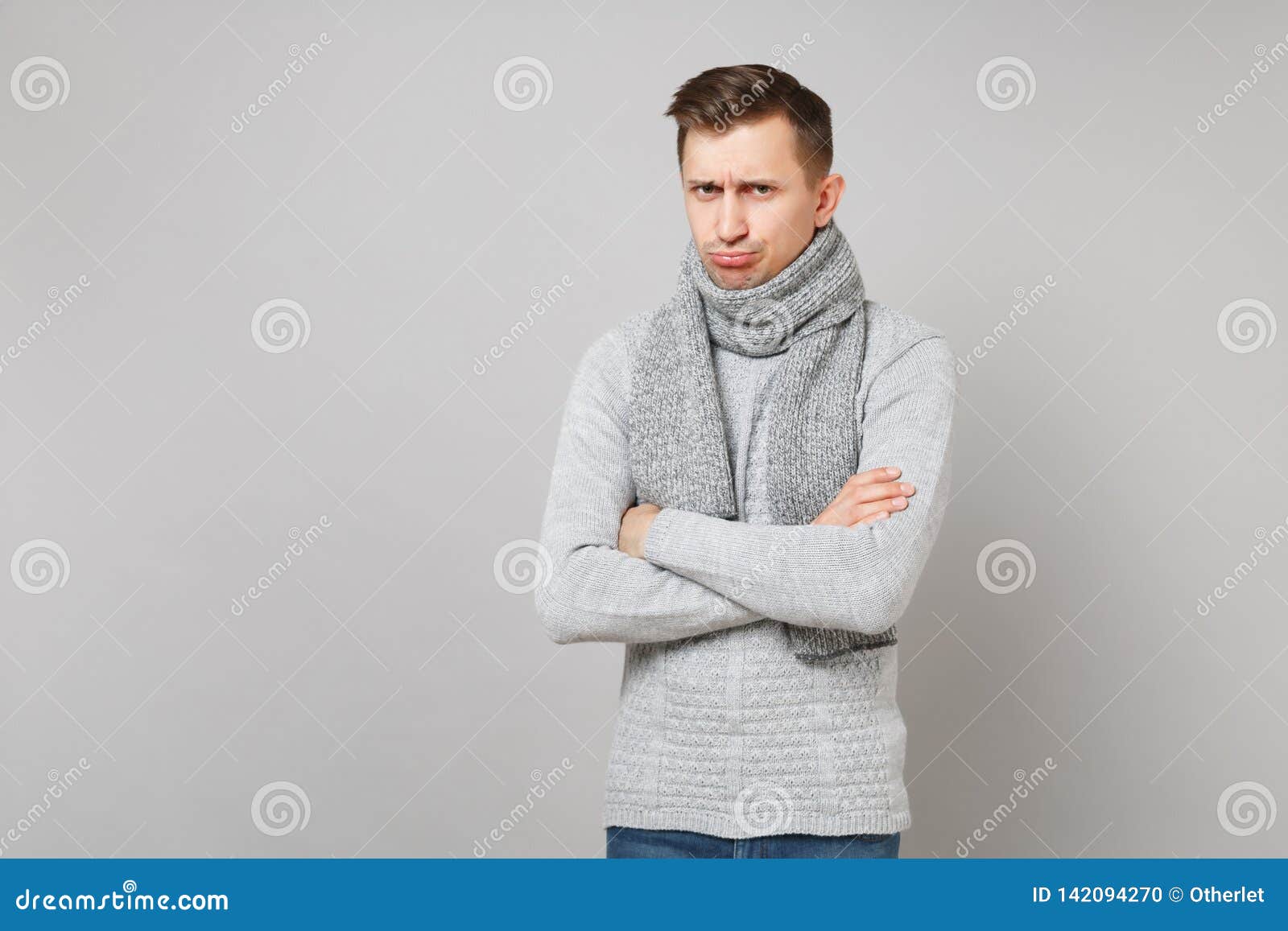 Resentful Young Man in Gray Sweater, Scarf Pouting Lips, Holding Hands ...