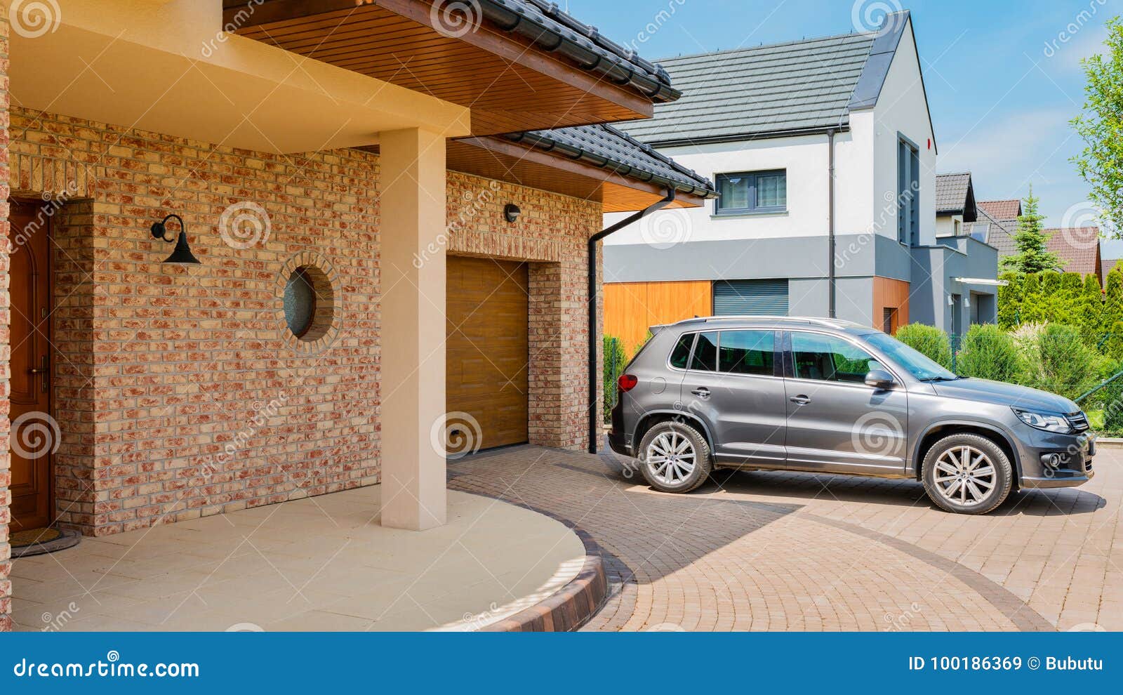 residential house with silver suv car parked on driveway in front